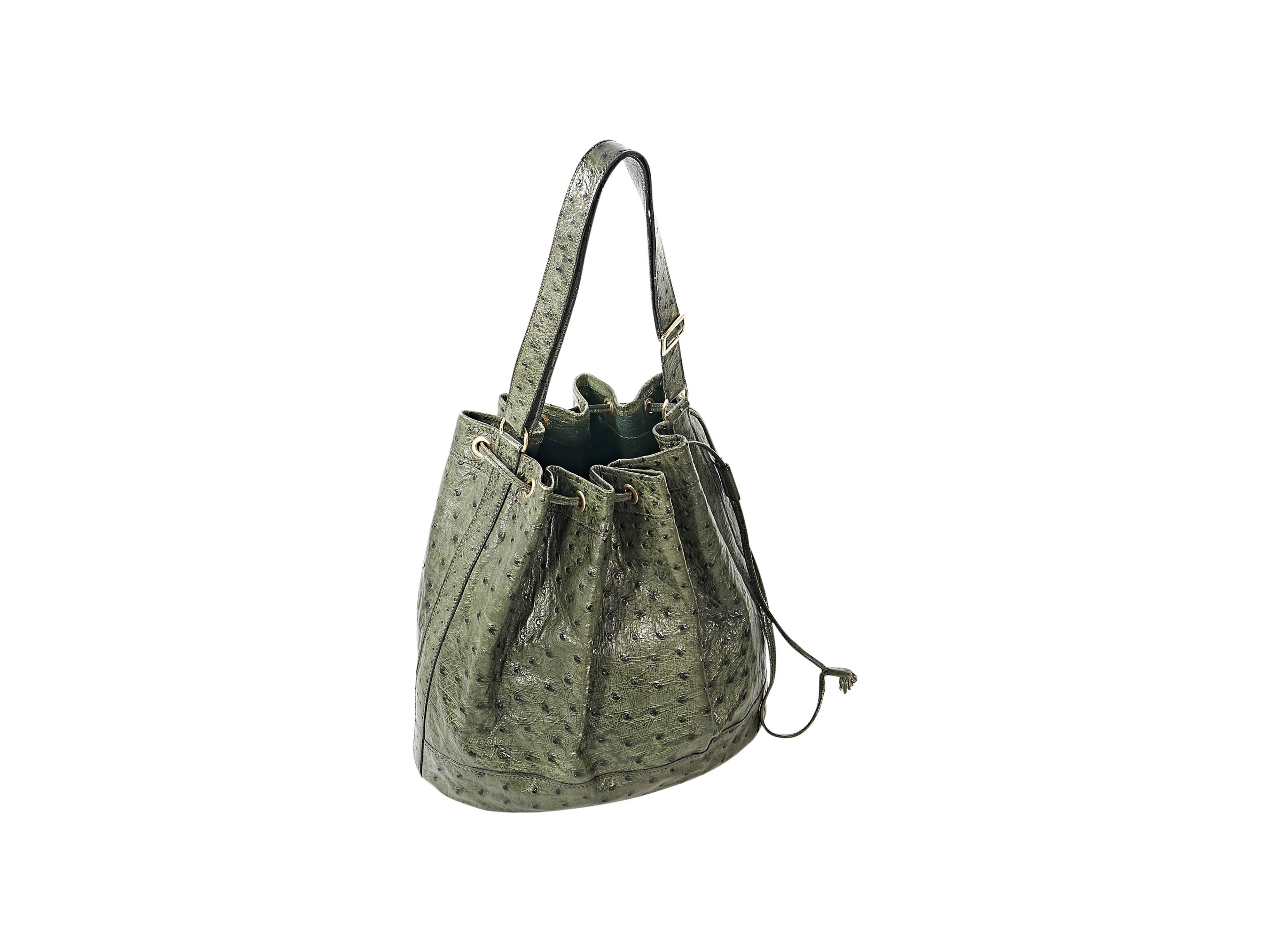 Product details:  Green ostrich vintage bucket bag by Hermes.  Single shoulder strap.  Drawstring closure.  Lined interior.  Goldtone hardware.  11"L x 10.5"H x 5"D.  9.25" strap drop.   
Condition: Good.  Moderate exterior and
