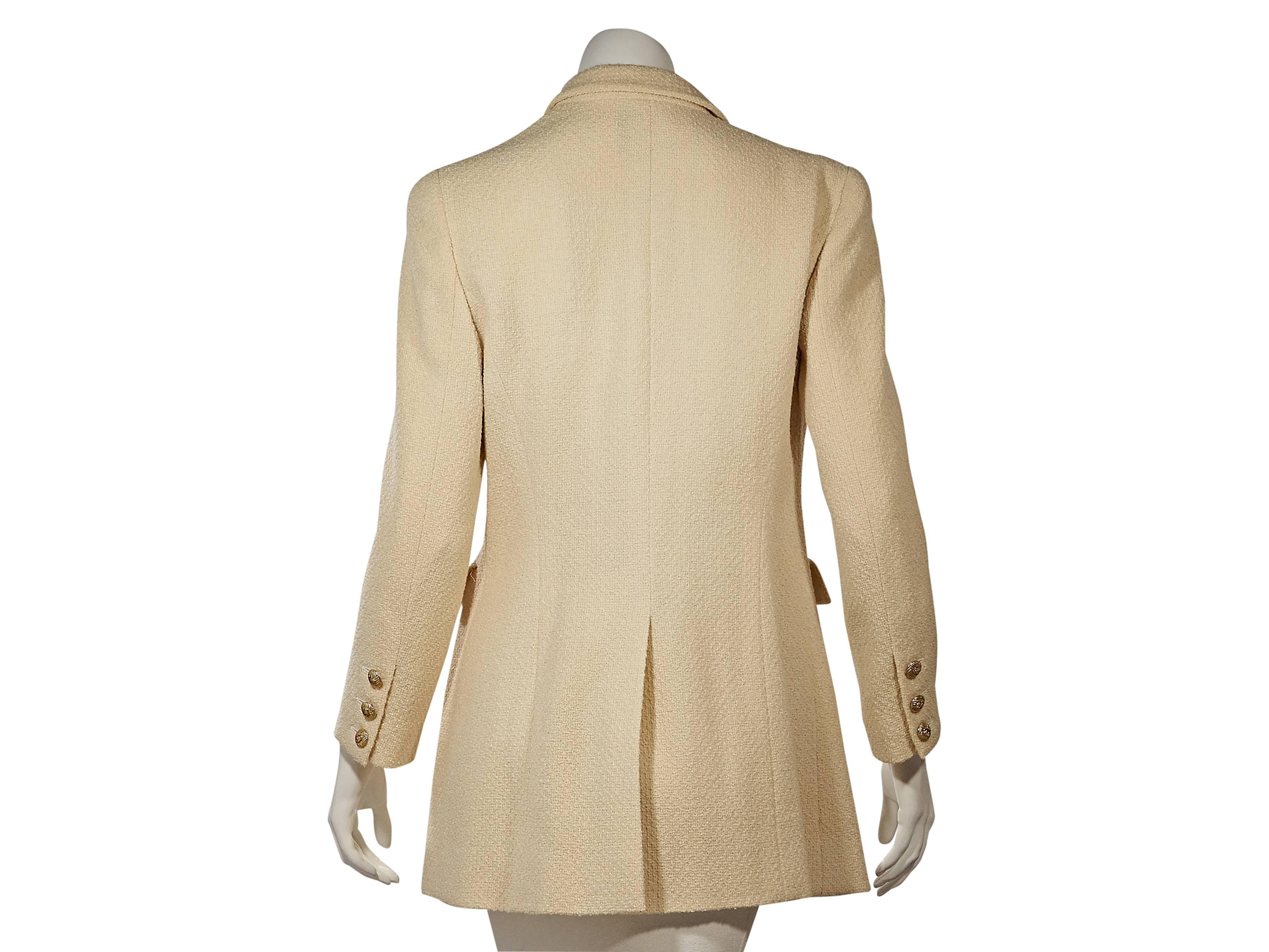 Product details:  ﻿Vintage cream textured jacket by Chanel.  Rounded notched lapel.  Long sleeves.  Triple-button detail at cuffs.  Button-front closure.  Waist flap pockets.  Back hem vent.   
Condition: Very good. 