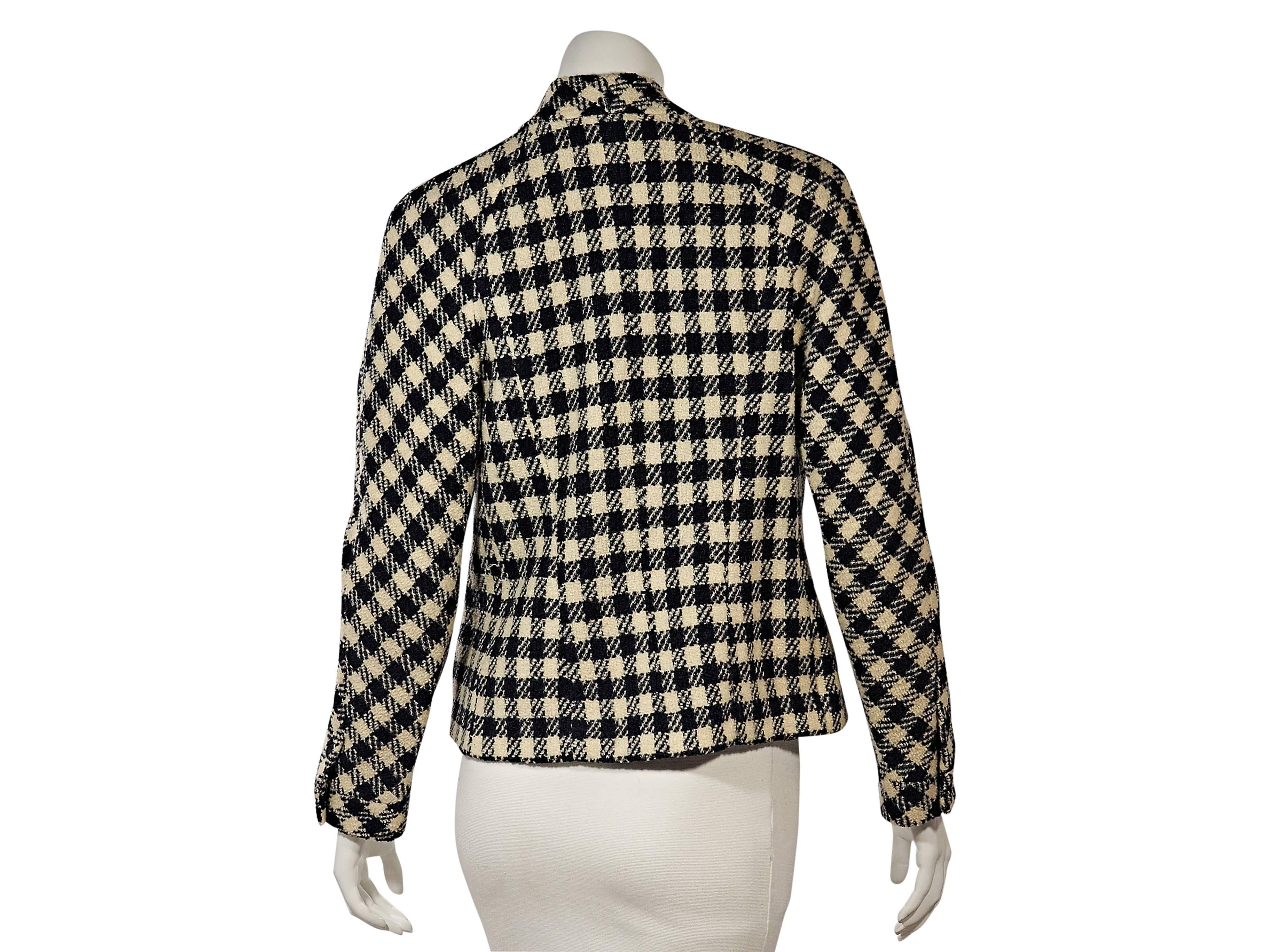 Product details: Vintage cream and blue checkered jacket by Chanel. Collar-less. Long sleeves. Button cuffs. Button-front closure. Button besom front pockets. 
Condition: Very good. 