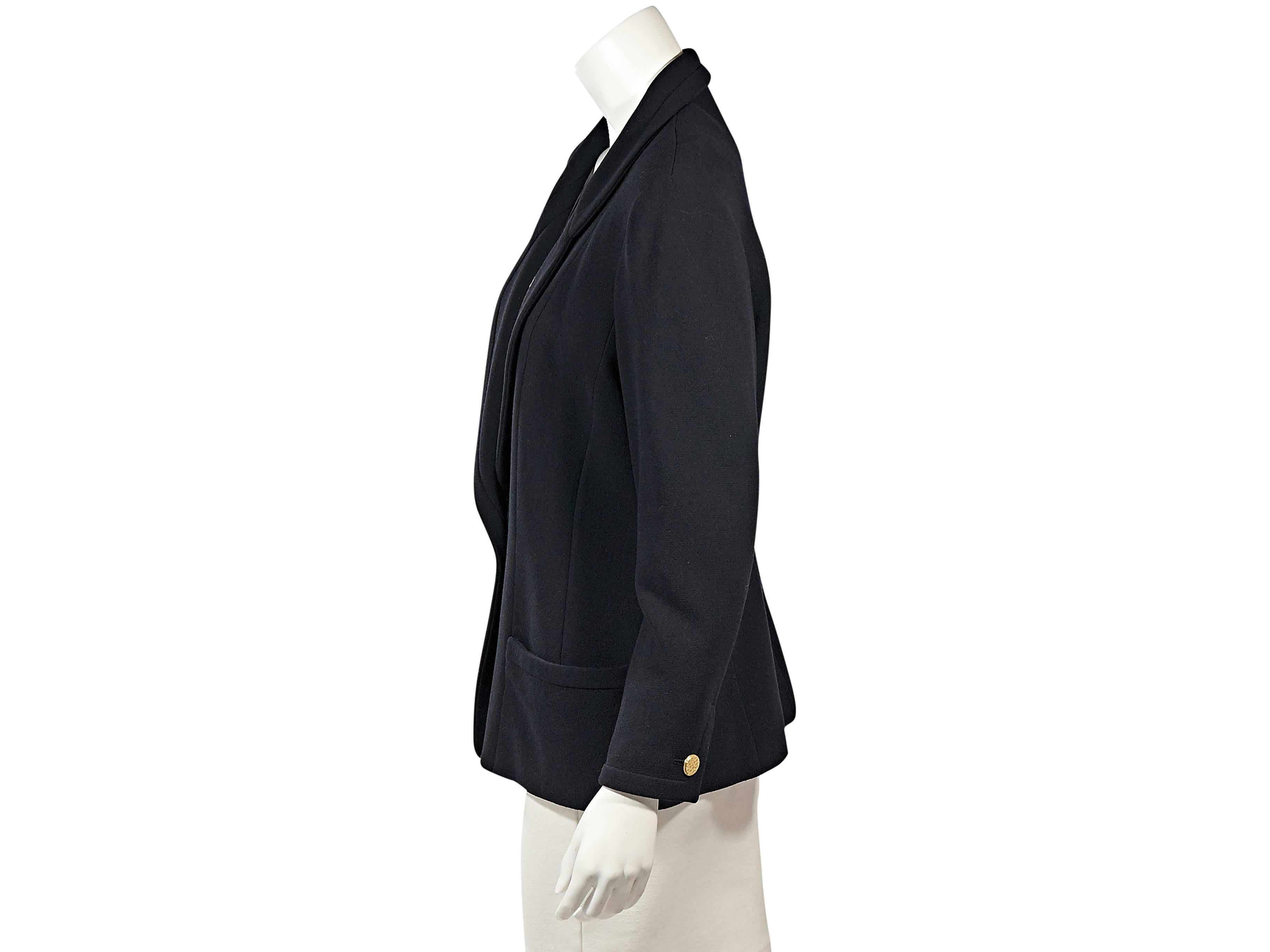 Product details: Vintage navy blazer by Chanel. Rounded notched lapel. Long sleeves. Button cuffs. Single-button closure. Front patch pockets.  42