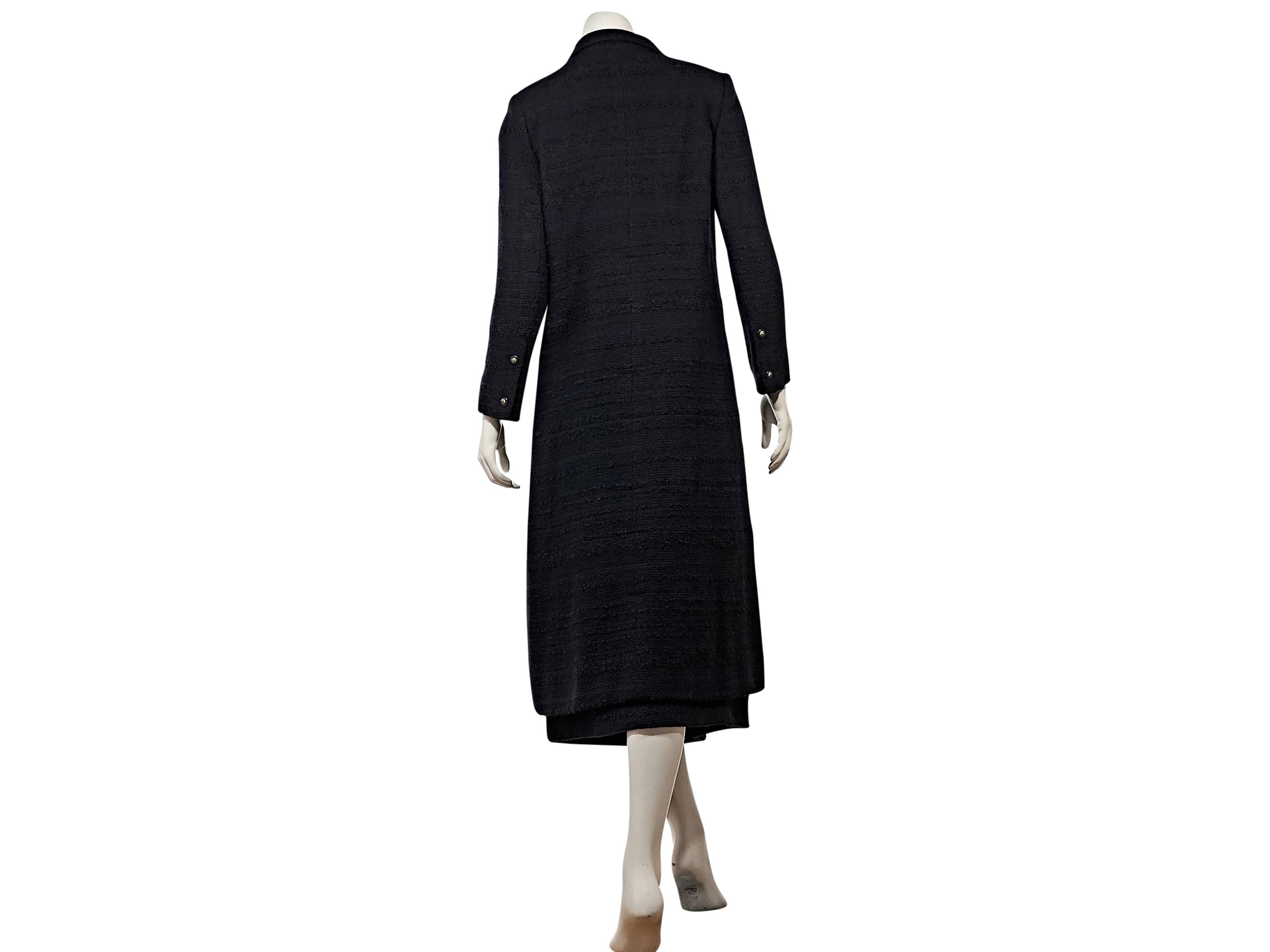 Product details: Vintage navy 2-piece skirt set by Chanel. Long jacket. Spread collar. Long sleeves. Double button detail at cuffs. Button-front closure. Four button besom pockets. Matching long skirt. Banded waist. Side slant pockets. 
Condition: