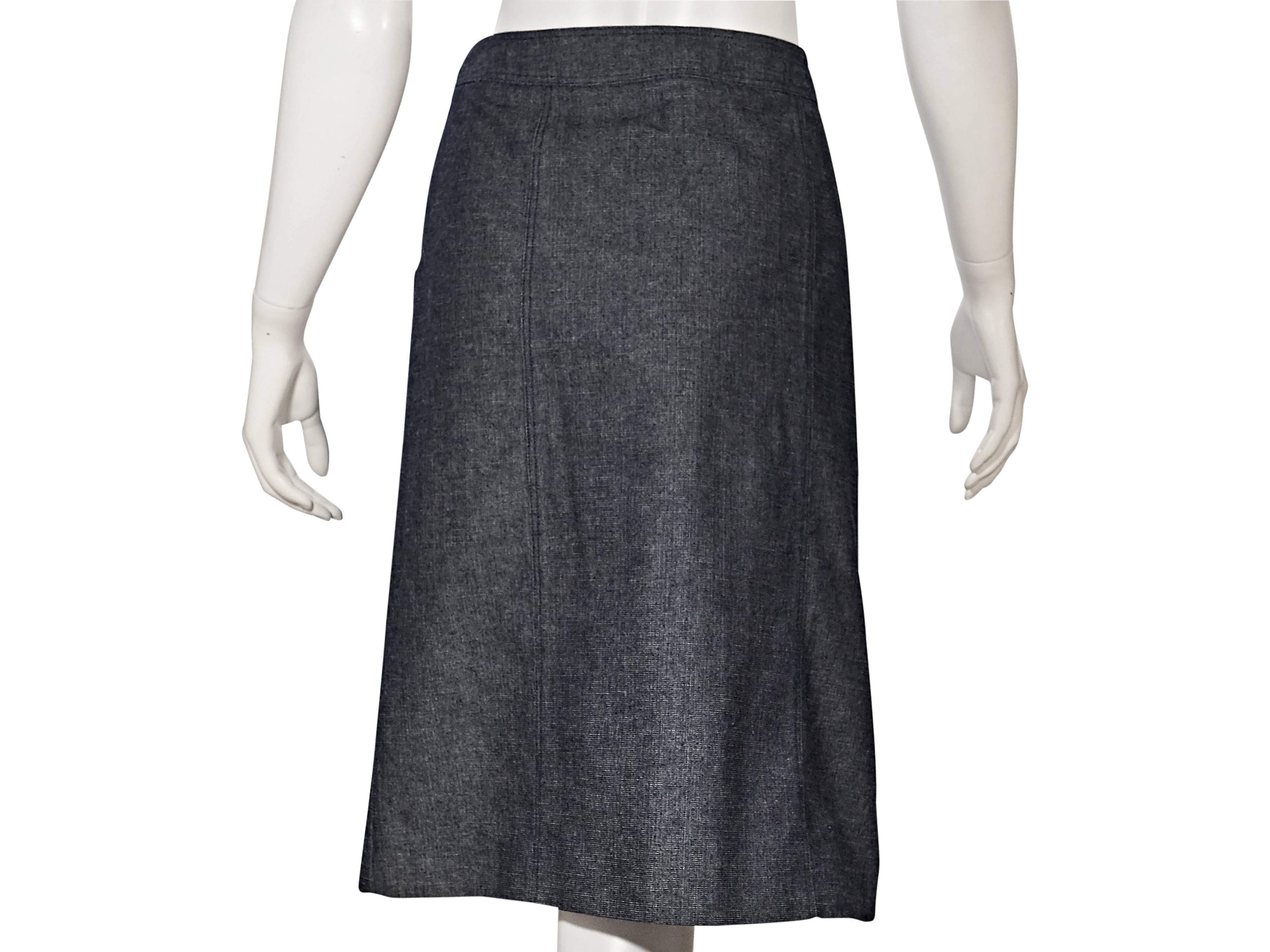 Product details:  ﻿Vintage denim A-line skirt by Chanel.  Banded waist.  Concealed side zip closure. 
Condition: Very good. 