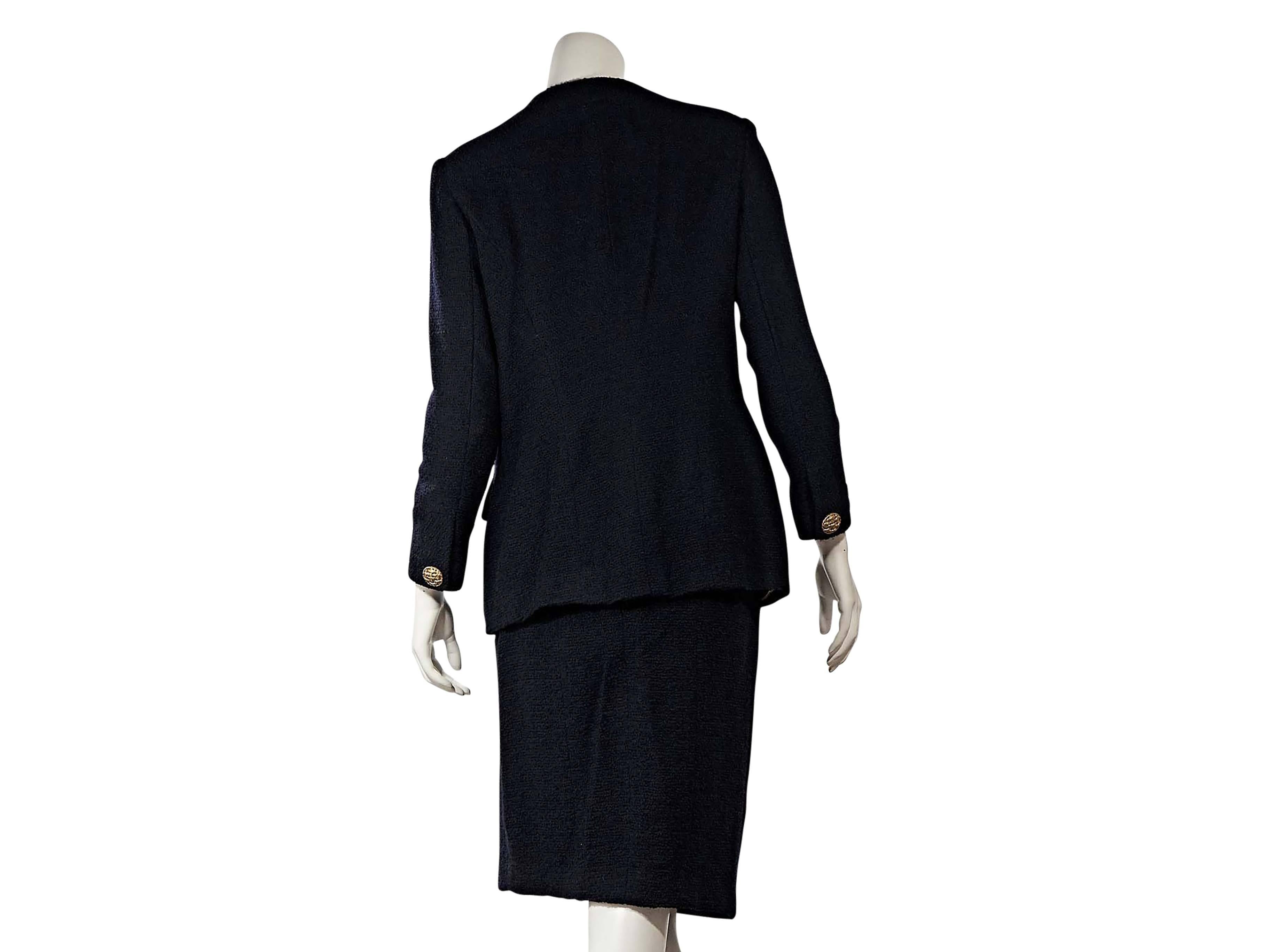Product details: Vintage navy skirt suit set by Chanel. Crewneck. Bracelet-length sleeves. Button cuffs and front. Flap pockets. Matching pencil skirt. Banded waist. 
Condition: Very good. 

