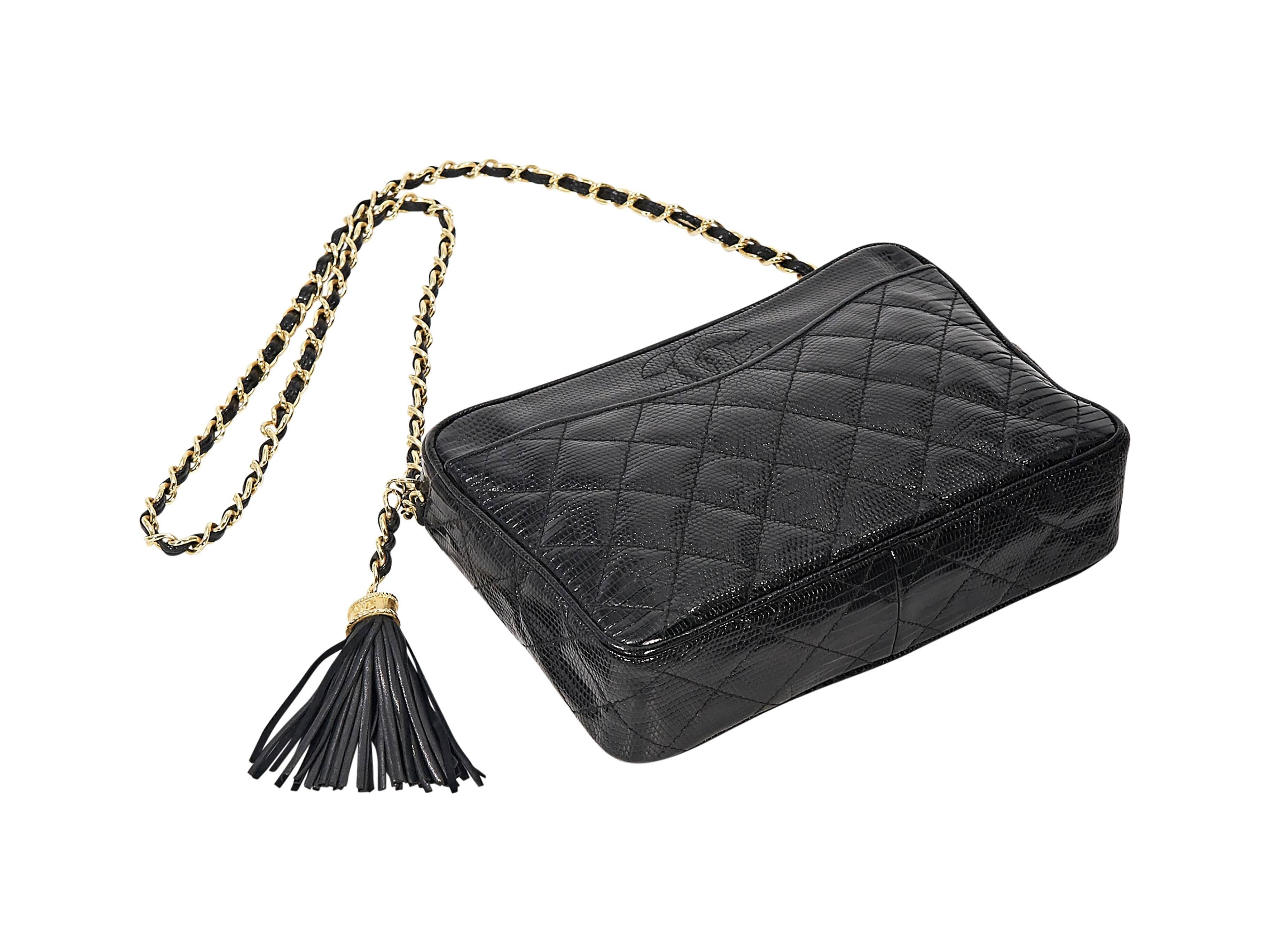 Product details:  Vintage black quilted lizard crossbody bag by Chanel.  Leather woven chain crossbody strap.  Top zip closure.  Tassel accent.  Leather lined interior with inner zip pocket.  Goldtone hardware.  9