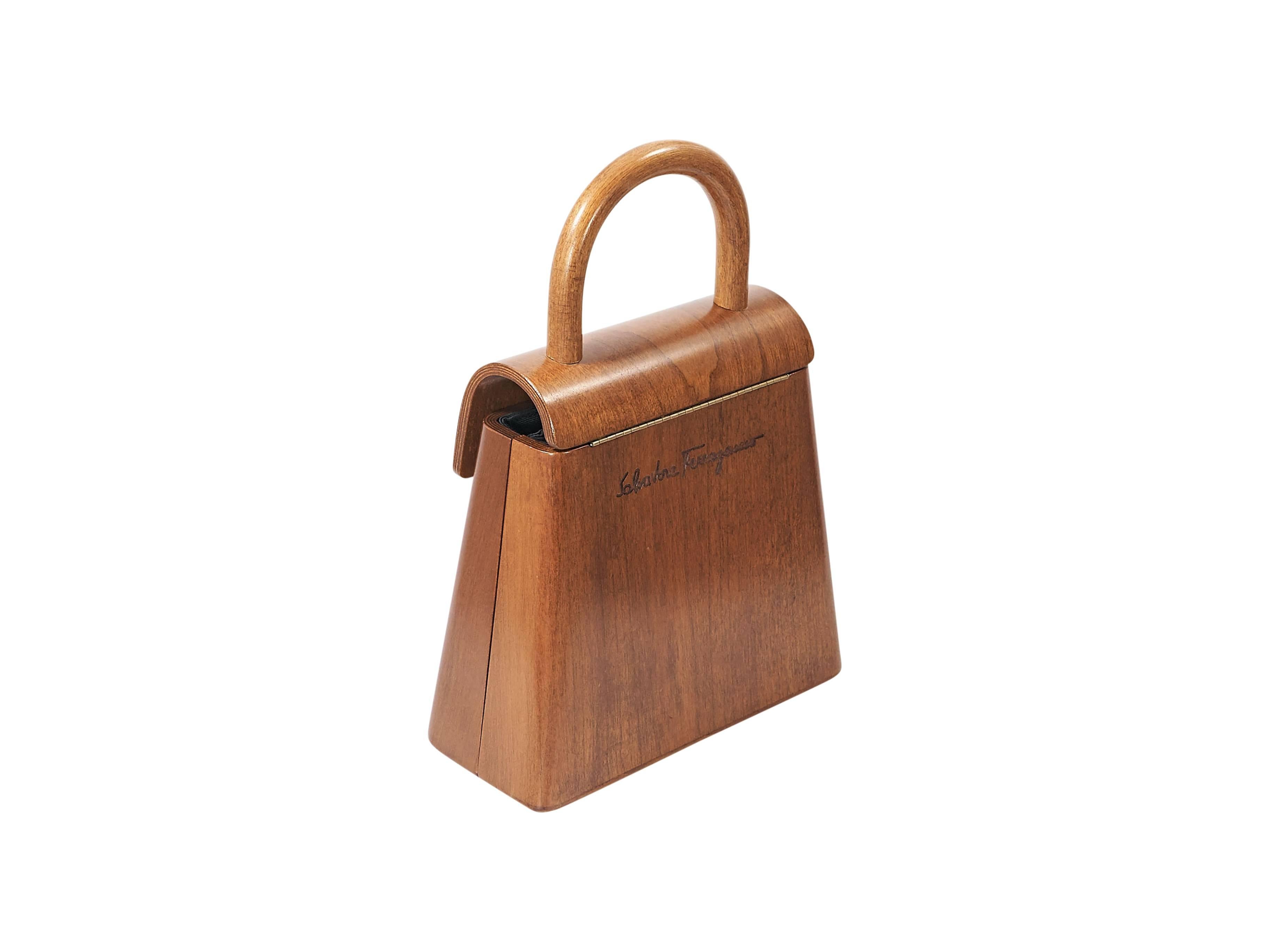 Product details: Brown carved wood handbag by Salvatore Ferragamo. Rare limited edition - #4/100. Top carry handle. Front flap with magnetic snap closure. Lined interior with inner slide pocket. Goldtone hardware. 7