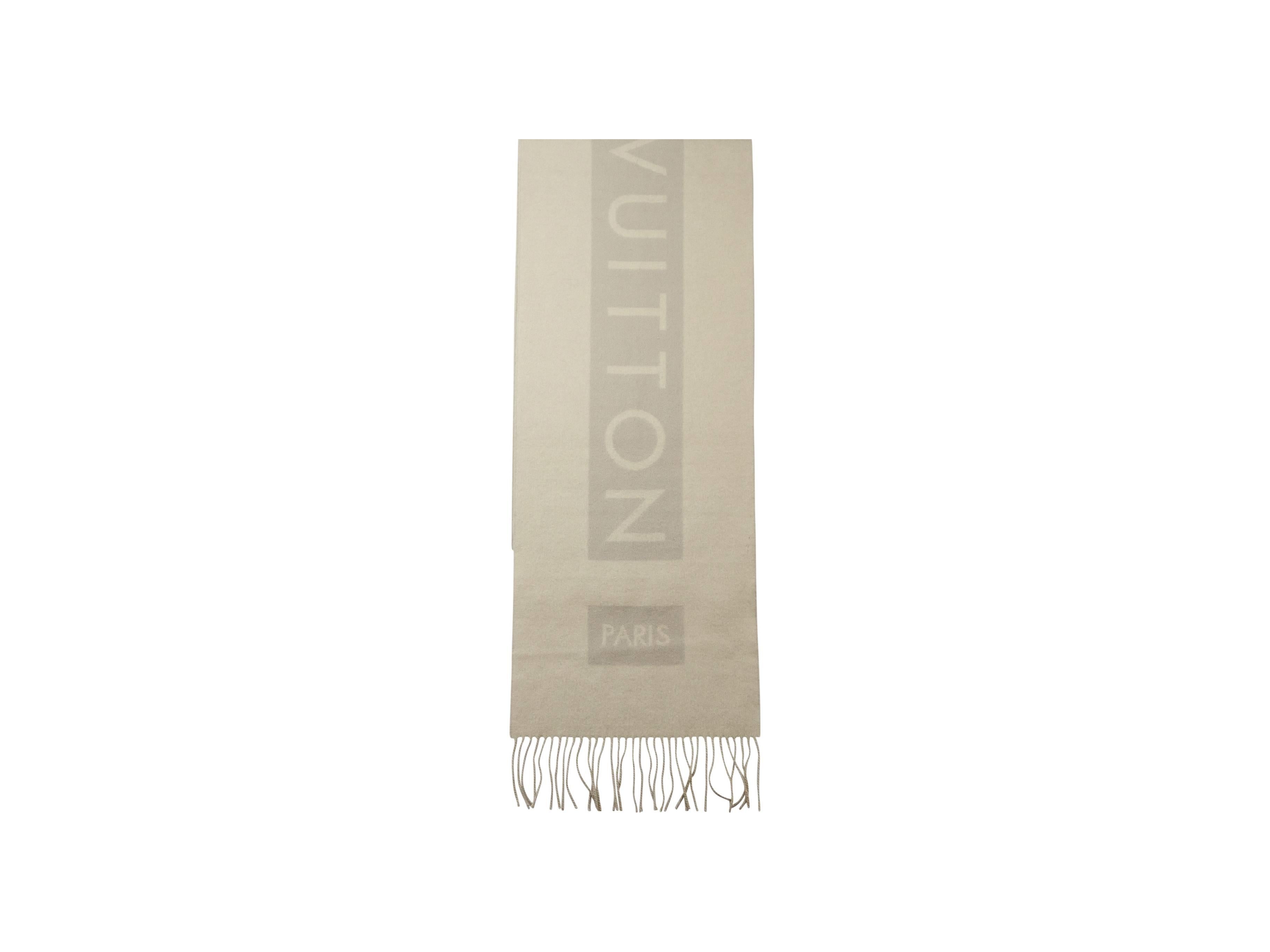 Product details: Light grey cashmere scarf by Louis Vuitton. Accented with tonal logo detail. Fringed trim. 
Condition: Excellent. 
Est. Retail $ 1,500.00