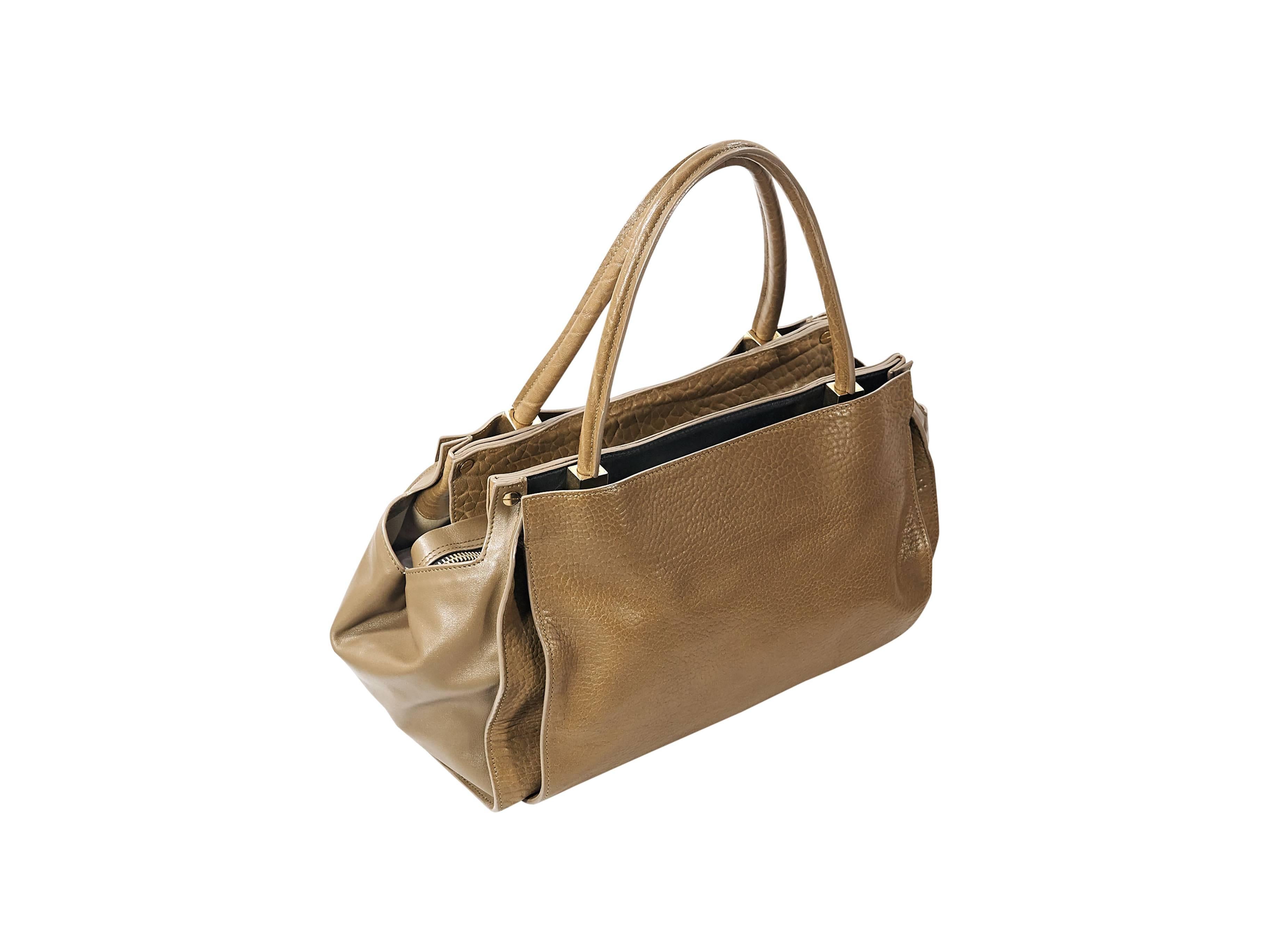 Product details: Tan leather Dree tote bag by Chloe. Dual shoulder straps. Zip closure. Lined interior with inner slide pockets. Protective metal feet. Goldtone hardware. 14