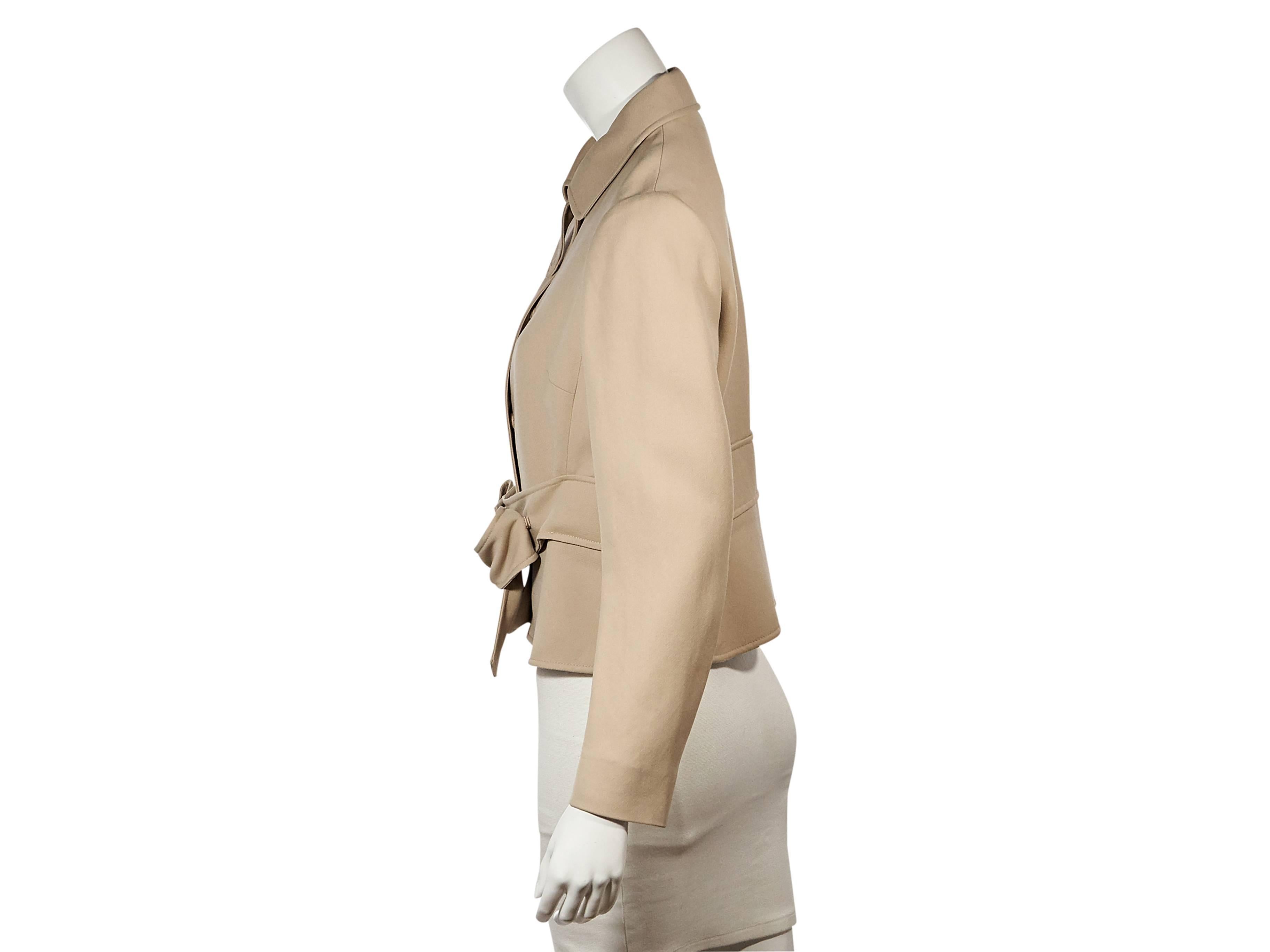 Product details:  Tan short coat by Valentino.  Point collar.  Long sleeves.  Concealed front closure.  Waist strap with bow accent.     
Condition: Excellent. 
Est. Retail $ 2,790.00