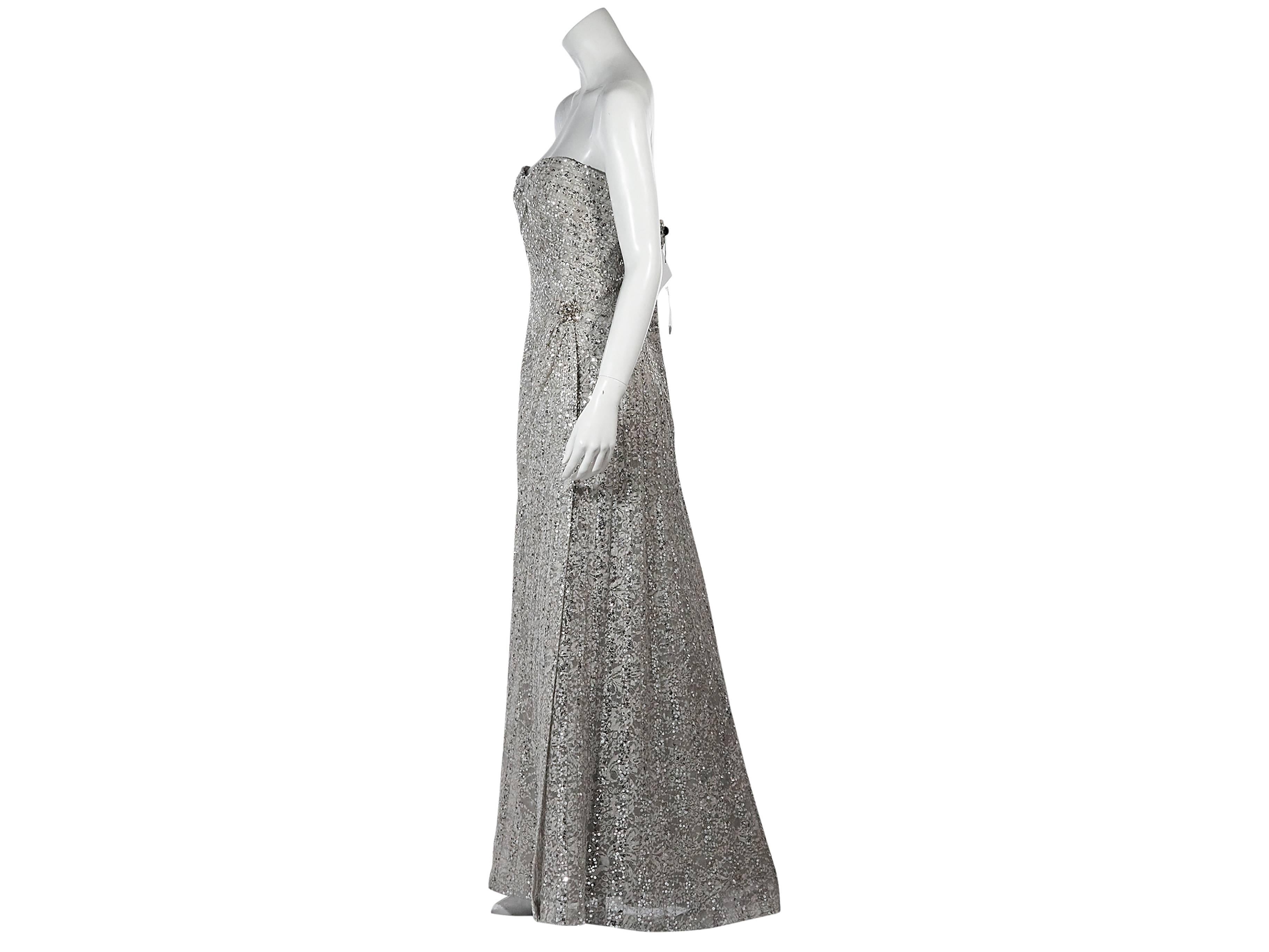 Product details:  Silver beaded lace gown by Carolina Herrera.  Strapless.  Sweetheart neck.  Embellished charm at hip.  Concealed back zip closure.  Inner zip-close support panel. 
Condition: New with tags. 
Est. Retail $ 4,228.00