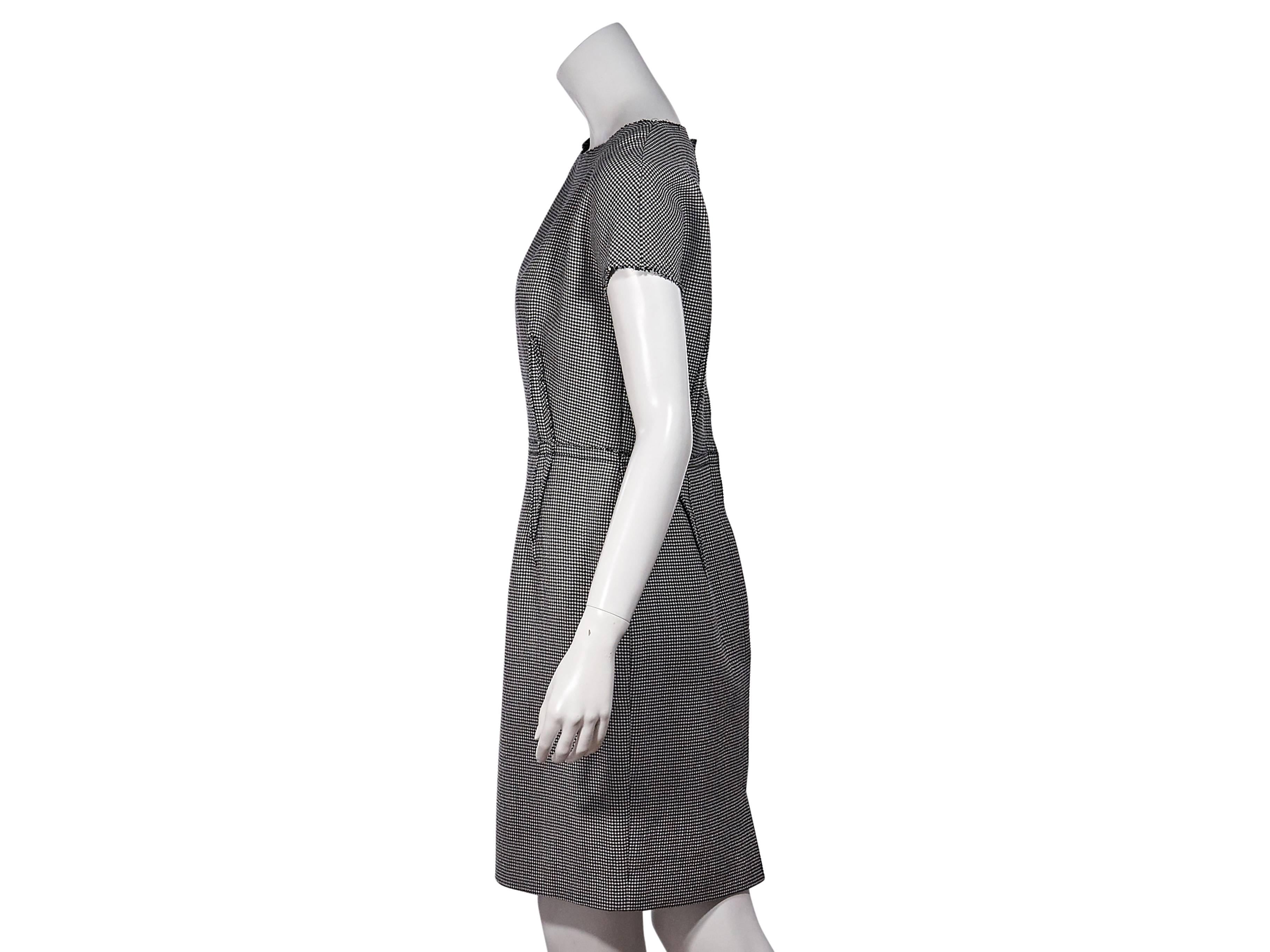 Product details: Black and white micro-houndstooth dress by Lanvin. Features and inside-out construction. Boat neck. Short sleeves. Concealed back zip closure. Back hem vent. Label size FR 40. 
Condition: Excellent. 
Est. Retail $ 528.00