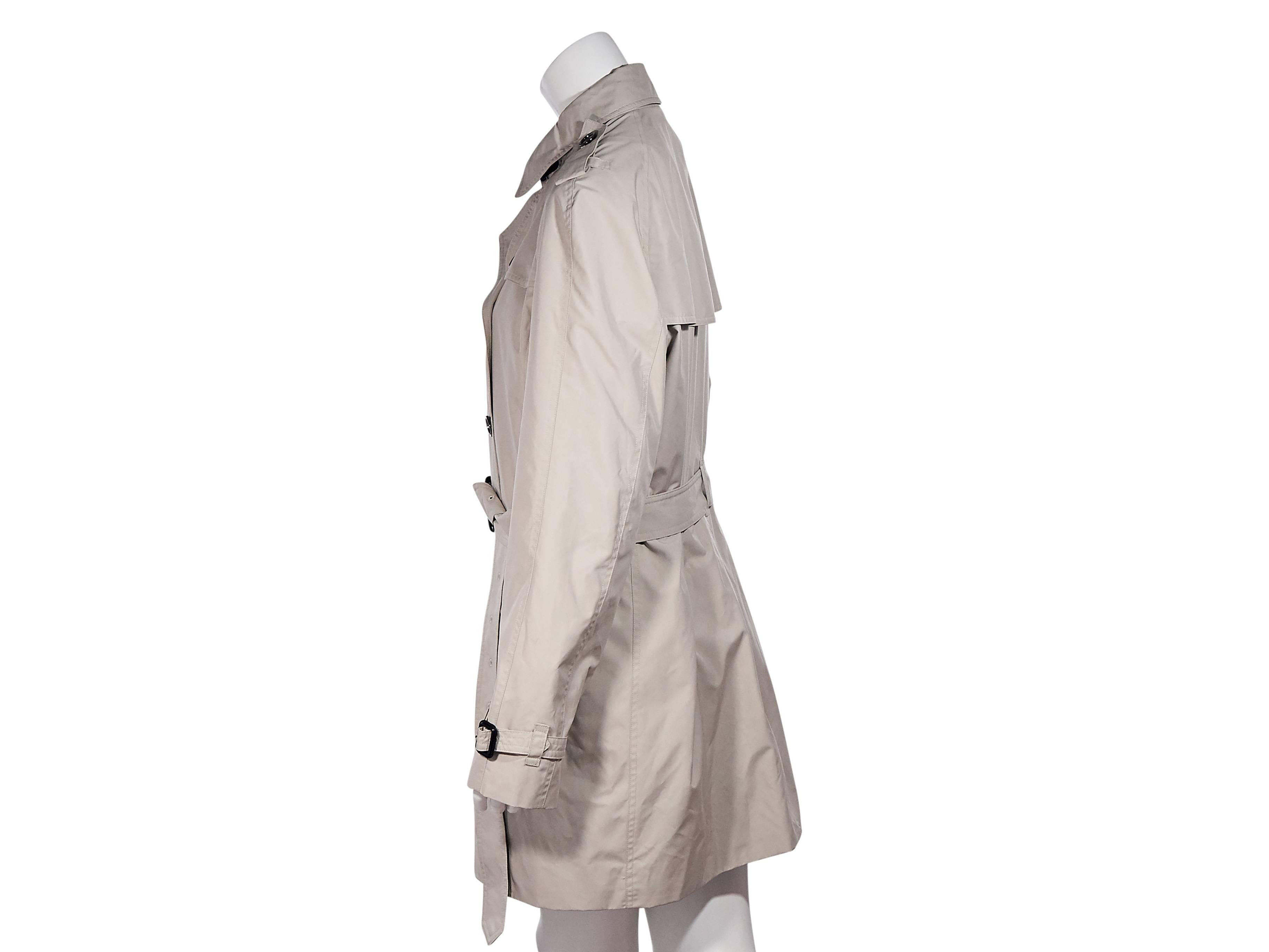 Product details: Tan cashmere trench coat by Burberry. Point collar. Shoulder epaulettes. Long sleeves. Adjustable cuff straps. Double-breasted button closure. Adjustable belted waist. Waist button pockets. Back storm vent and hem vent. 
Condition: