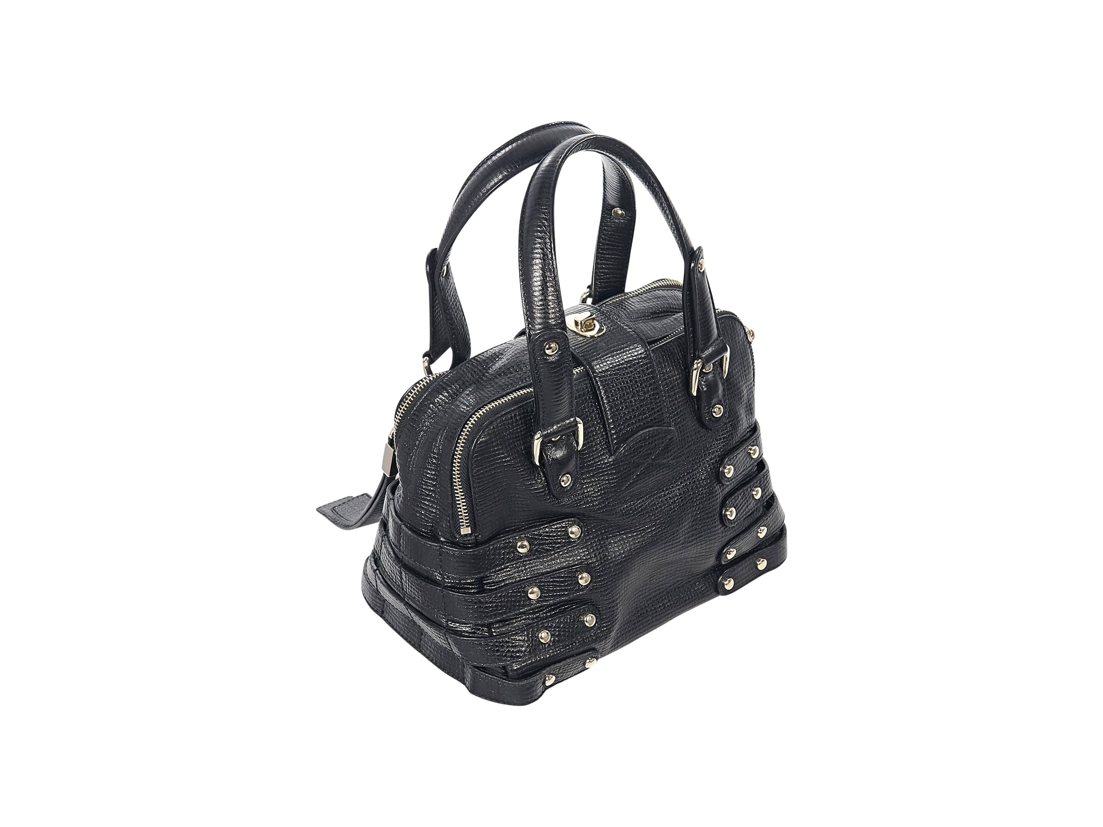 Product details: Black embossed small Bree tote bag by Jimmy Choo. Accented with multiple side straps. Dual carry handles. Twist-lock strap over two zip-close main compartments. Lined interior with inner slide and zip pockets. Protective metal feet.