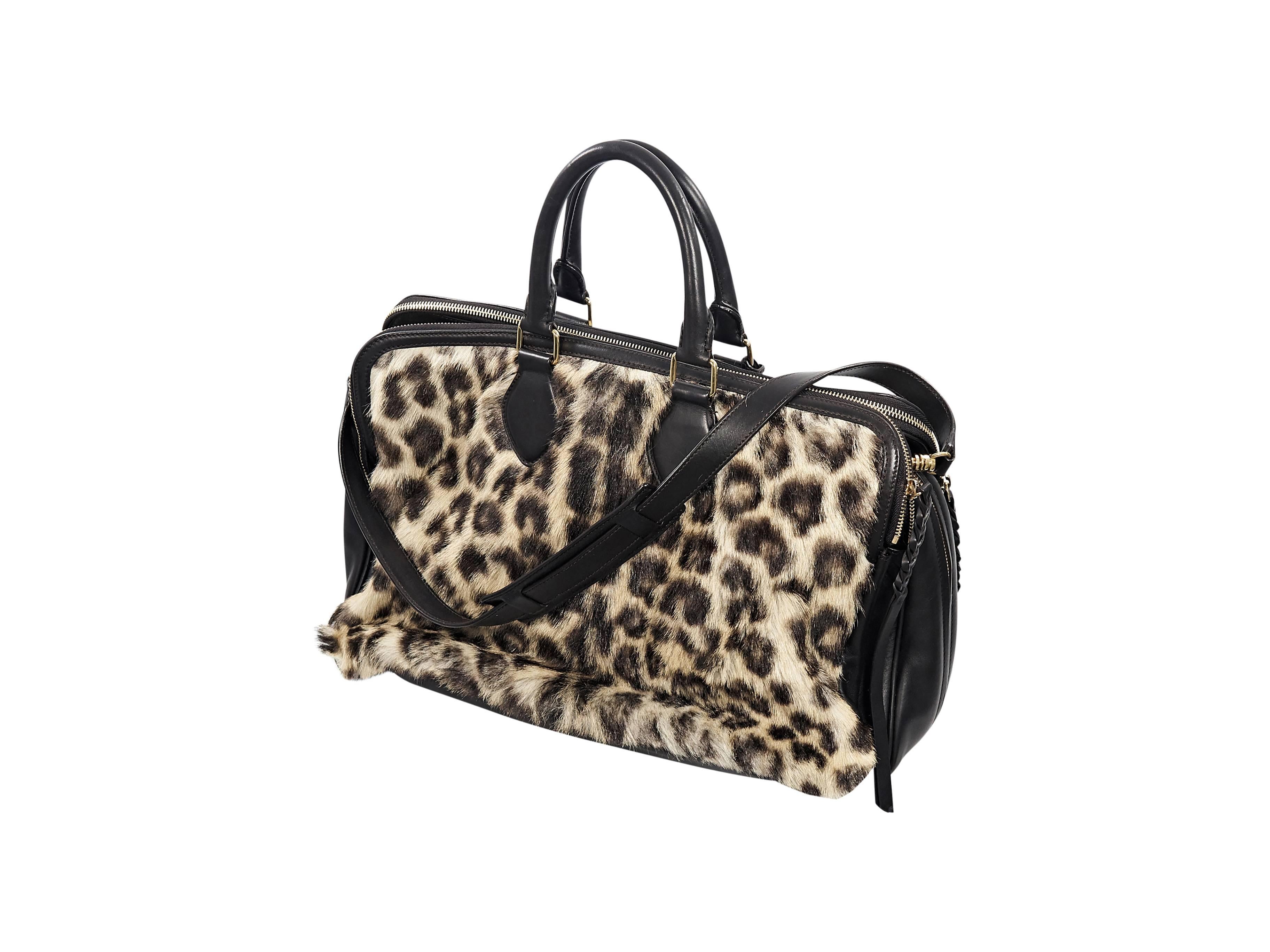 Product details:  Leopard-print goat fur satchel with black leather by Celine.  Top carry handles.  Detachable shoulder strap.  Three main compartments.  Top zip closures.  Lined interiors with slide pockets.  Goldtone hardware.  16