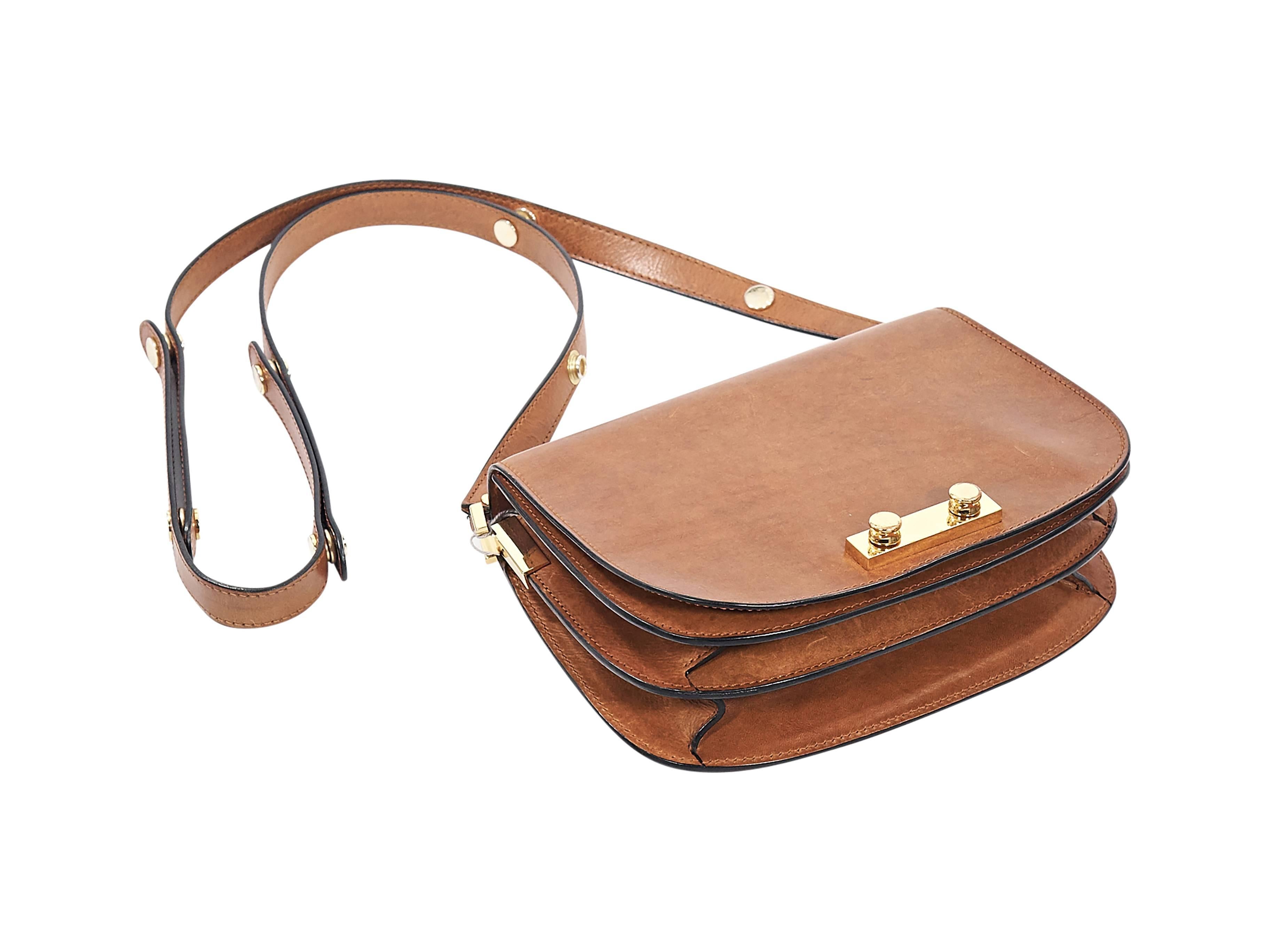 Product details:  Tan leather crossbody bag by Marni.  Adjustable crossbody strap.  Front flap.  Lined interior with inner compartments and slide pocket.  Goldtone hardware.  9