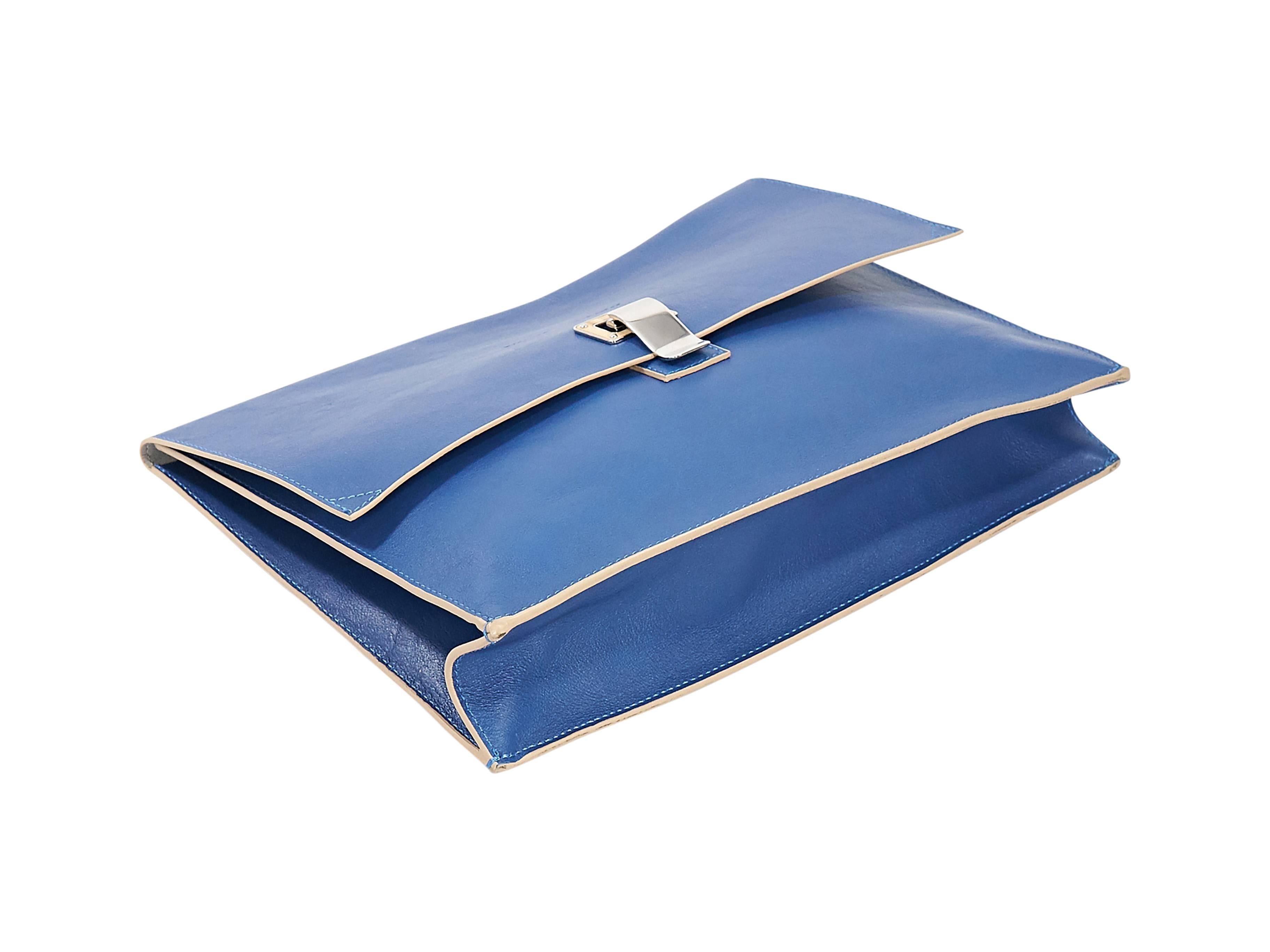 Product details:  Cobalt blue leather lunch bag clutch by Proenza Schouler.  Flip-lock closure.  Lined interior.  Back exterior slide pocket.  Silvertone hardware.  11.5