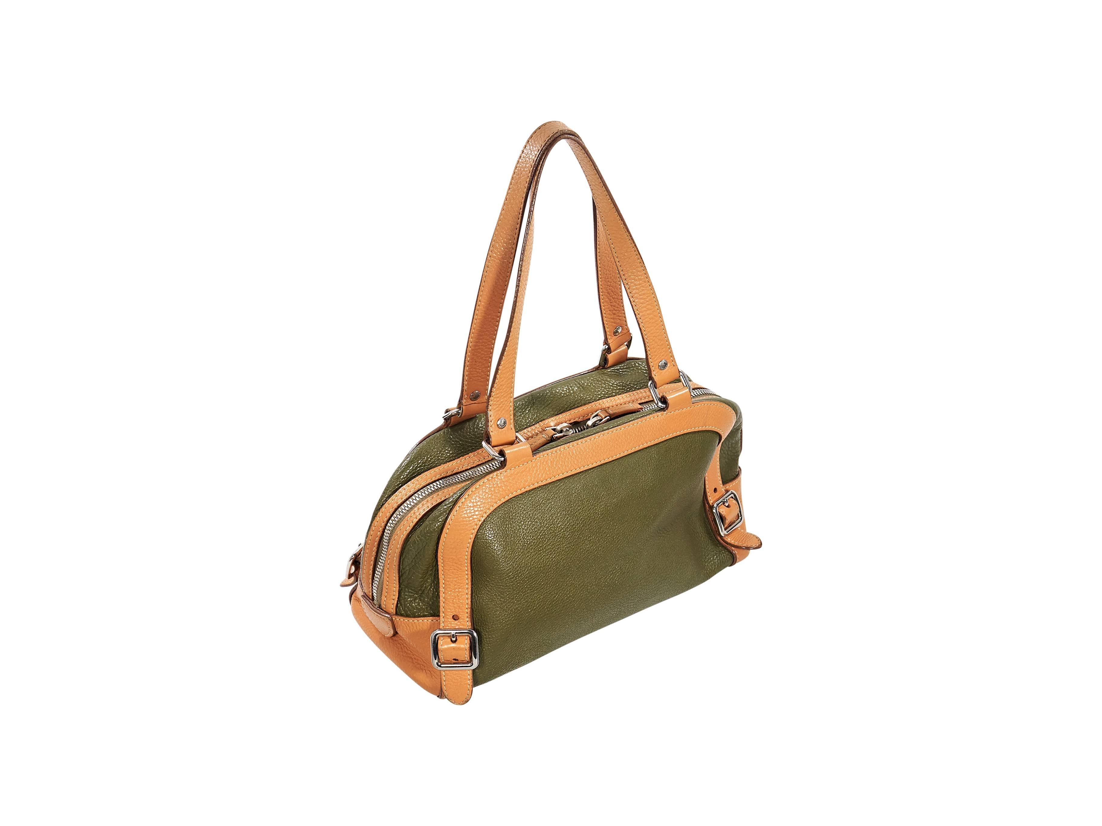 Product details:  Green and tan leather shoulder bag by Prada.  Accented with buckle strap details.  Dual shoulder straps.  Top dual zip closure.  Lined interior with inner zip pockets.  Front exterior zip pocket.  Silvertone hardware.   
Condition: