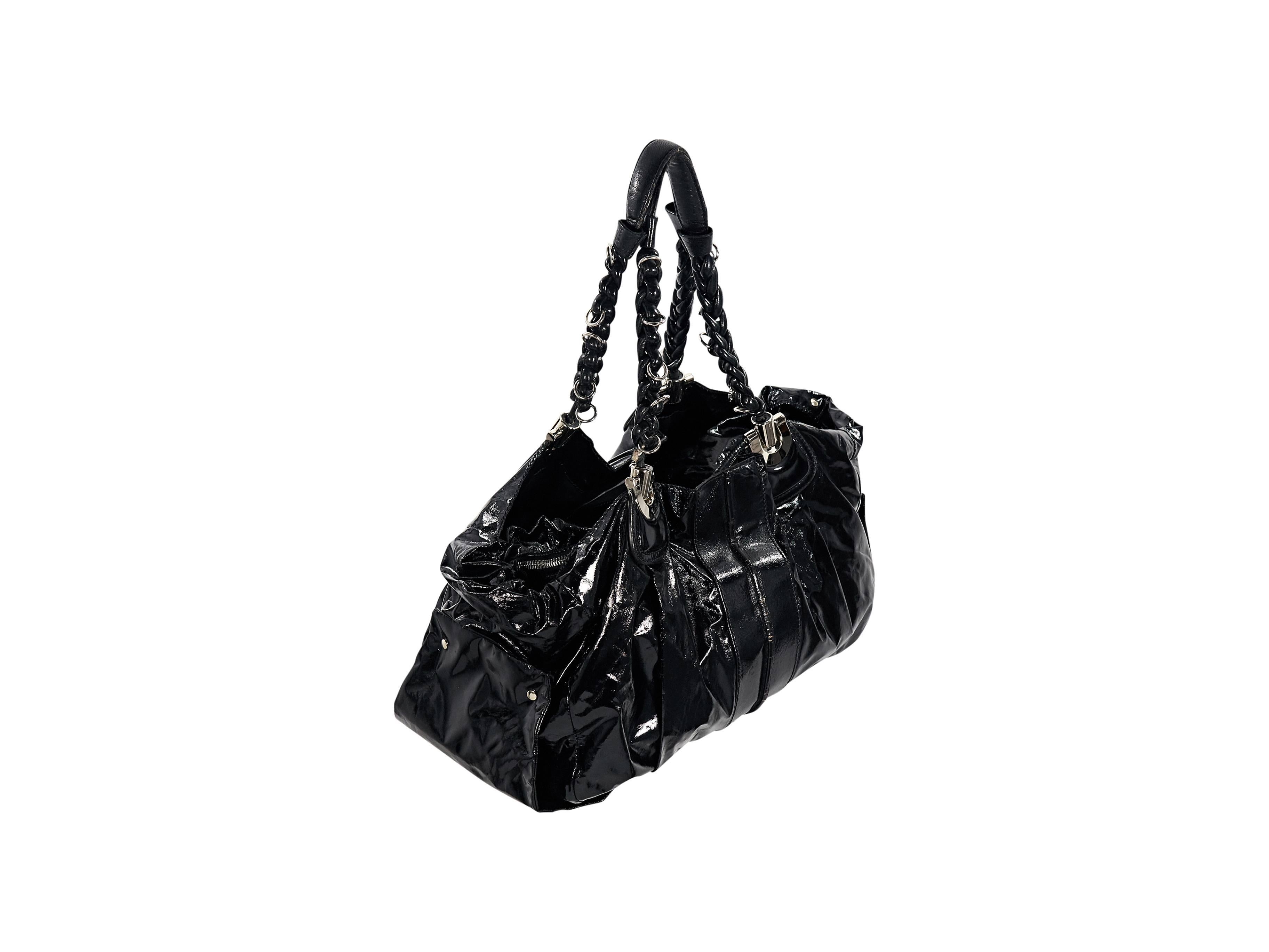 Product details: Black patent leather shoulder bag by Chloe. Dual braided shoulder straps. Lined interior with open and zip compartment. Protective metal feet. Silvertone hardware. Authenticity card included. 17.5