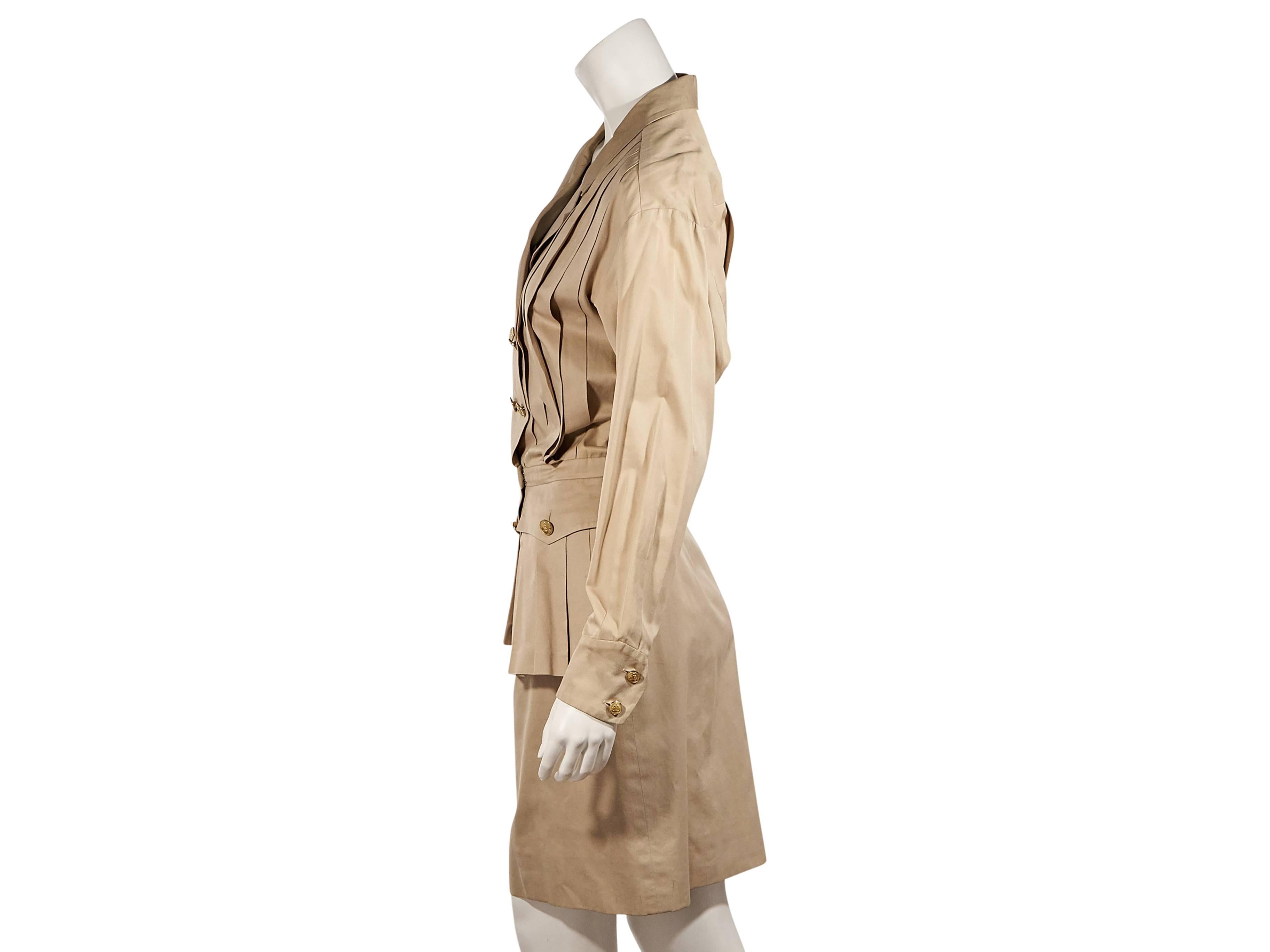 Product details:  Vintage tan pleated dress by Chanel.  Notched lapel.  Long sleeves.  Double button cuffs.  Double-breasted button front.  Banded waist.  Button-flap waist pockets.  
Condition: Excellent. 
Est. Retail $ 2,348.00