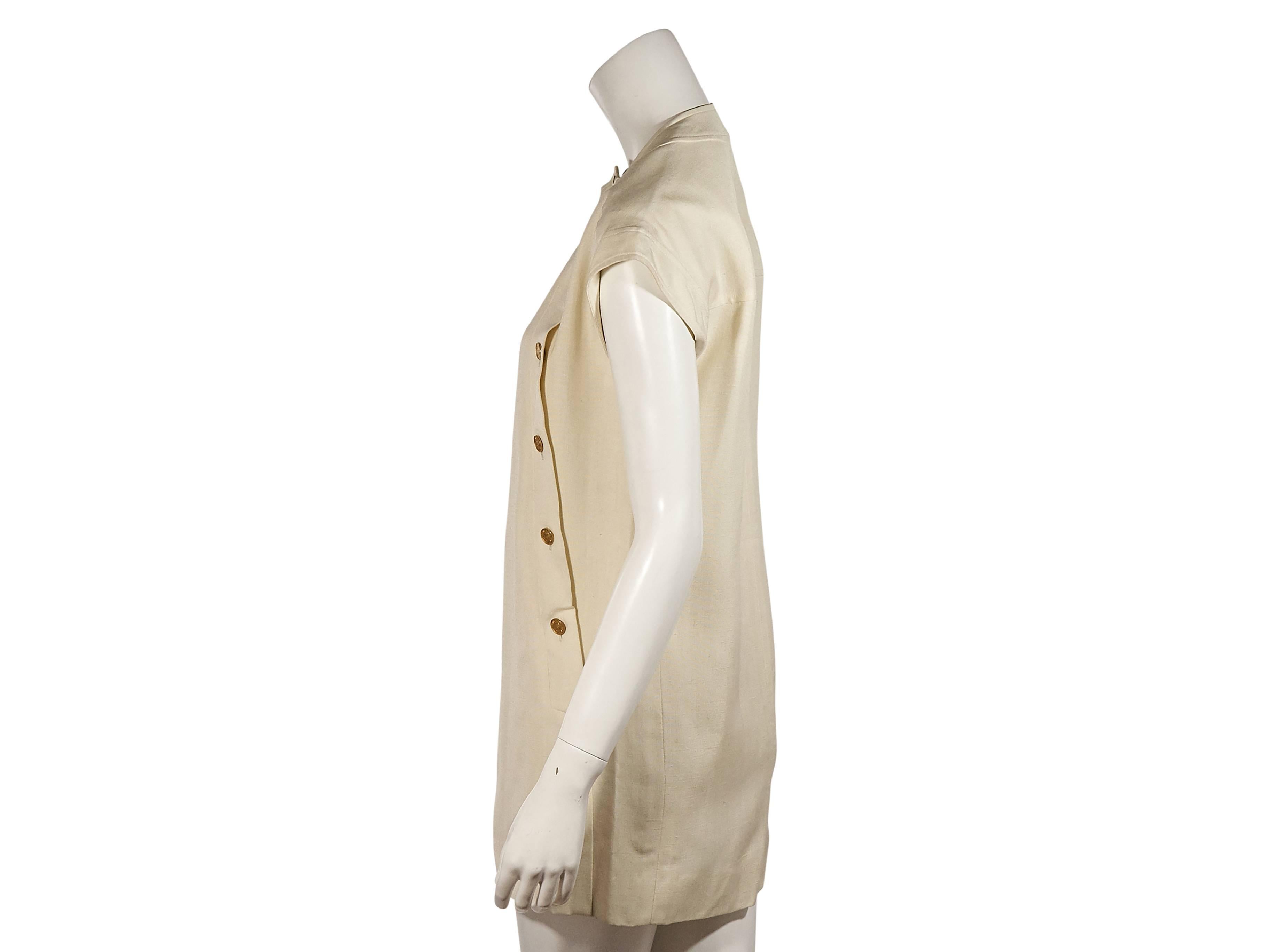 Product details:  Vintage cream mini dress by Chanel.  Crewneck.  Short dolman sleeves.  Asymmetrical button-front closure.  Label size FR 36.  
Condition: Excellent. 
Est. Retail $ 1,798.00