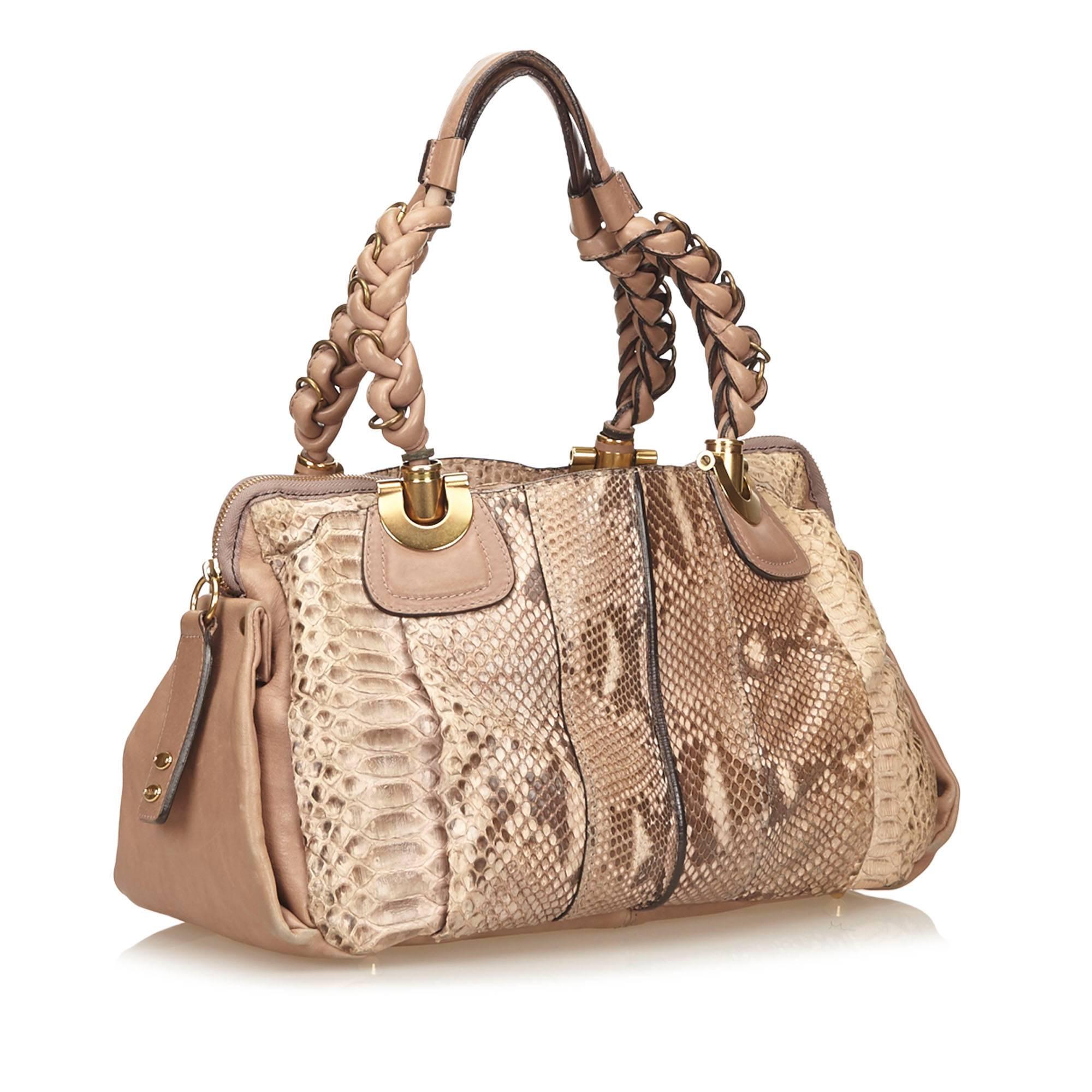Product details:  Brown python Heloise shoulder bag by Chloé.  Trimmed with leather.  Dual braided shoulder straps.  Top zip closure.  Lined interior with inner zip and slide pockets.  Protective metal feet.  Goldtone hardware.  15