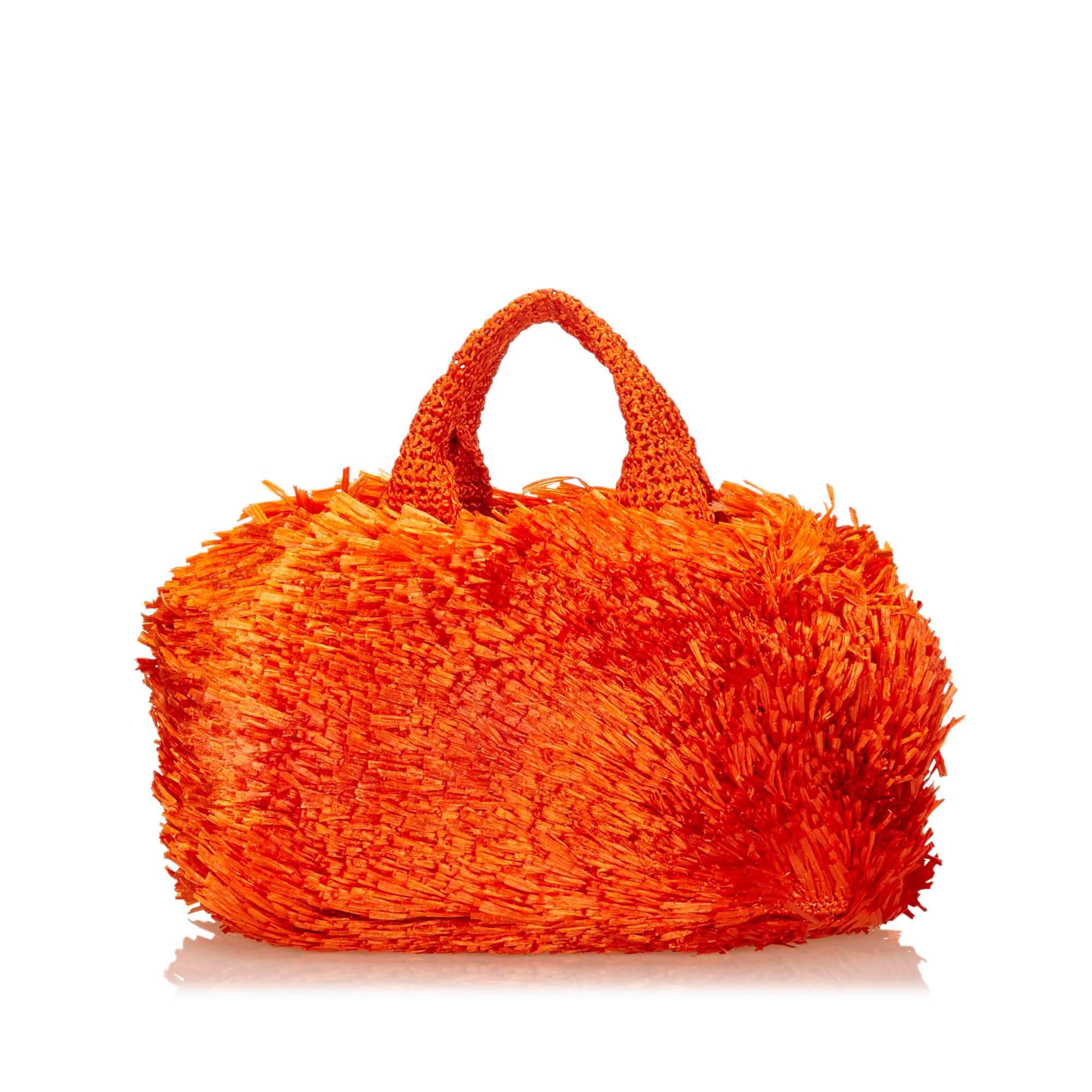 Product details:  Orange raffia handbag by Prada.  Top woven carry handles.  Open top.  Lined interior with inner zip and slide pockets.  15