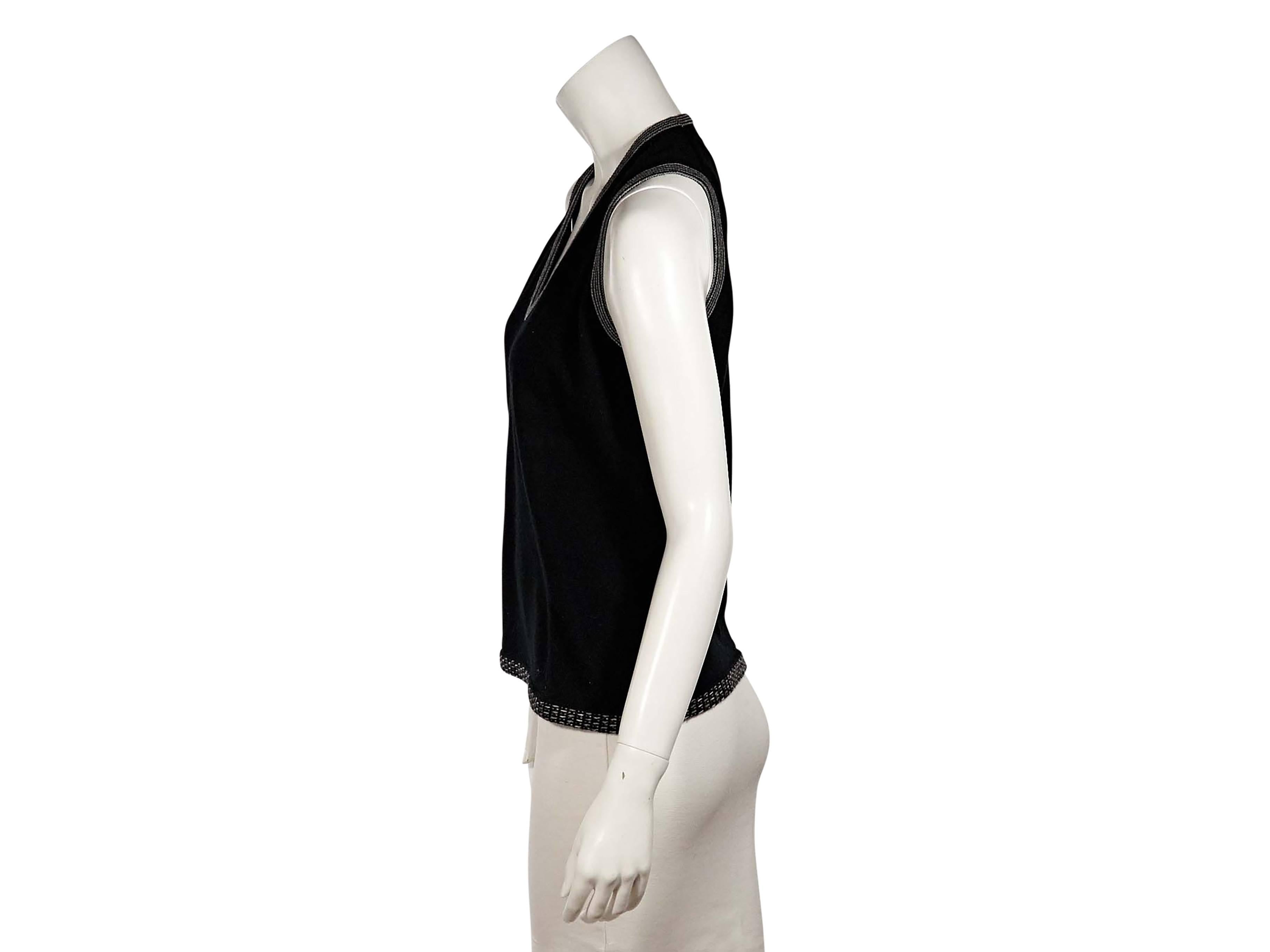 Product details:  Black knit sweater shell by Chanel.  Features contrast trim.  U-neck.  Sleeveless.  Pullover style.  Label size FR 44.  
Condition: Excellent. 
Est. Retail $ 748.00
