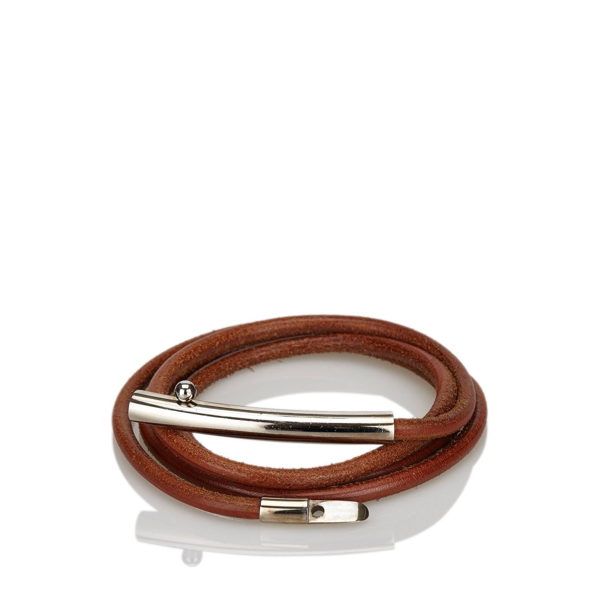 Product details:  Brown rolled leather belt by Hermès.  Clasp closure.  Silvertone hardware.  63