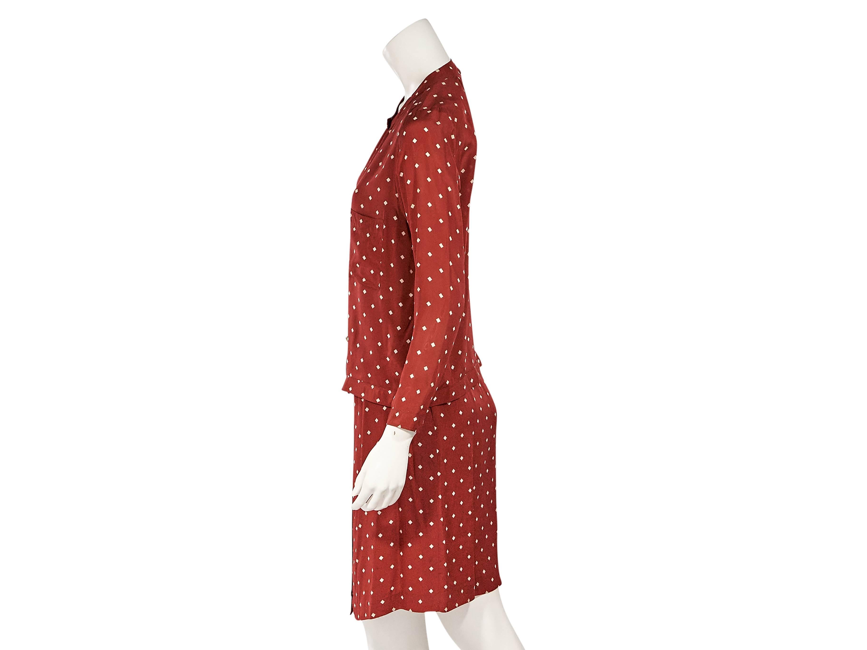 Product details:  Red vintage printed silk skirt set by Chanel.  Crewneck.  Long sleeves.  Button-front closure.  Chest patch pockets.  Matching skirt.  Banded waist.  Button-front closure.  
Condition: Very good. 
Est. Retail $ 1,228.00