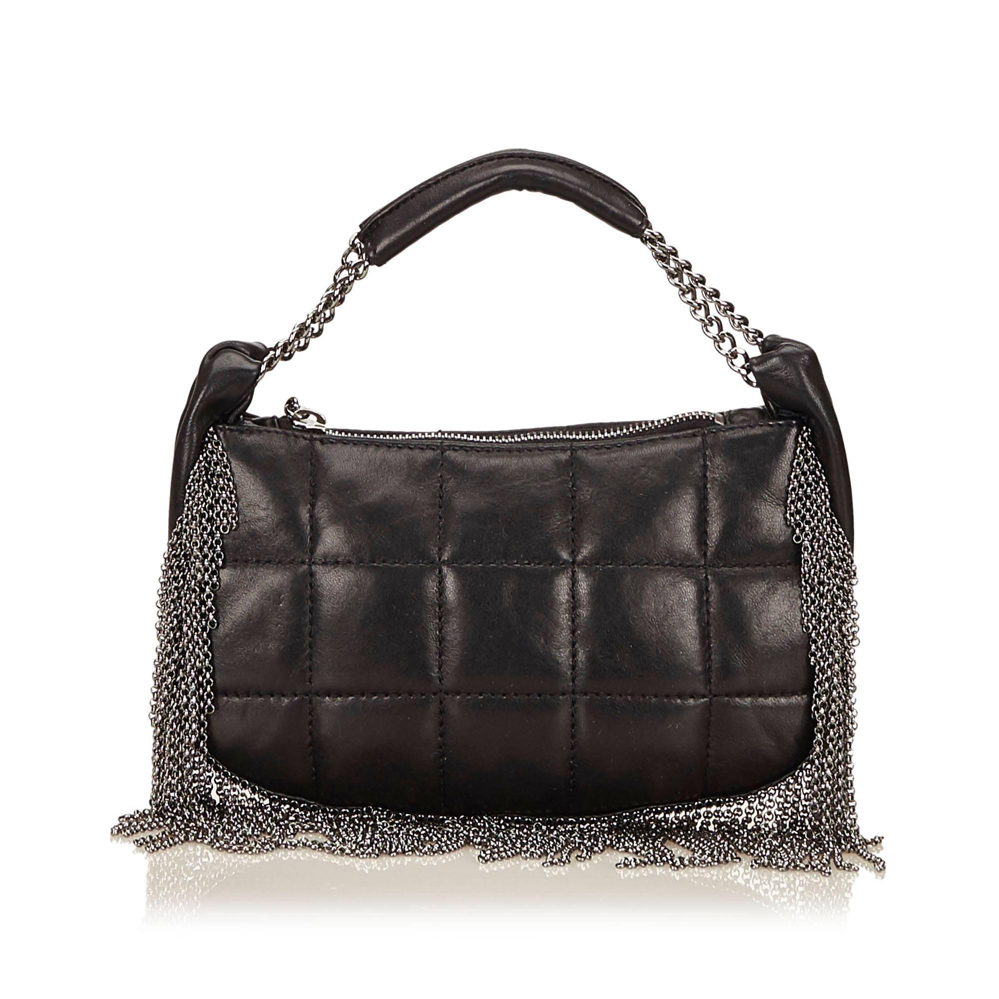 Product details:  Chocolate brown quilted lambskin leather shoulder bag by Chanel.  Accented with metal fringe.  Single shoulder strap.  Top zip closure.  Lined interior with inner pockets.  Silvertone hardware.  Dust bag included.  8.75