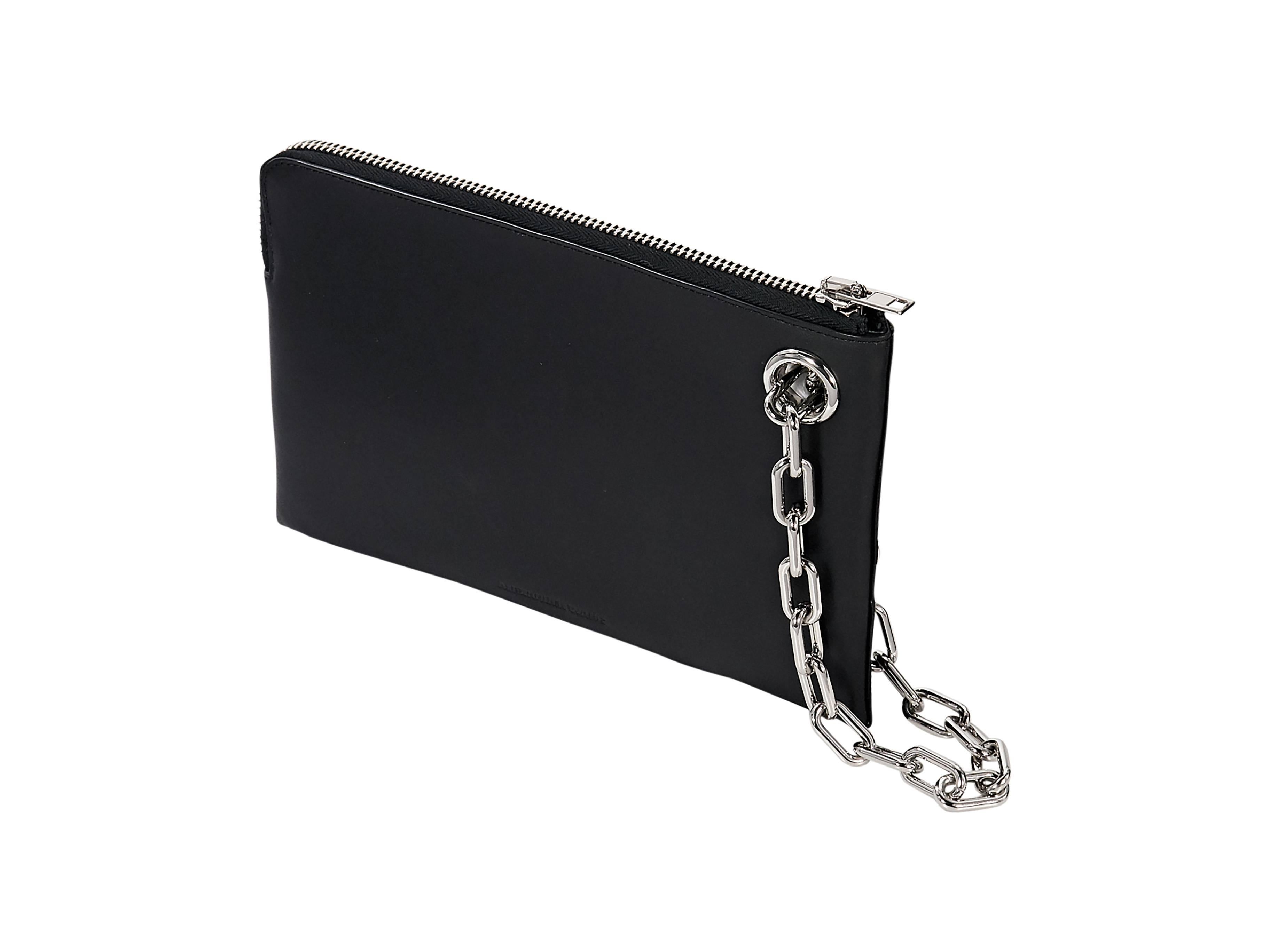 Product details: Black leather clutch by Alexander Wang. Silvertone hardware. Chain wristlet. Top zip closure. Exterior zip pocket. Lined interior with inner zip pocket. 
Condition: Very good. 
Est. Retail $ 730.00