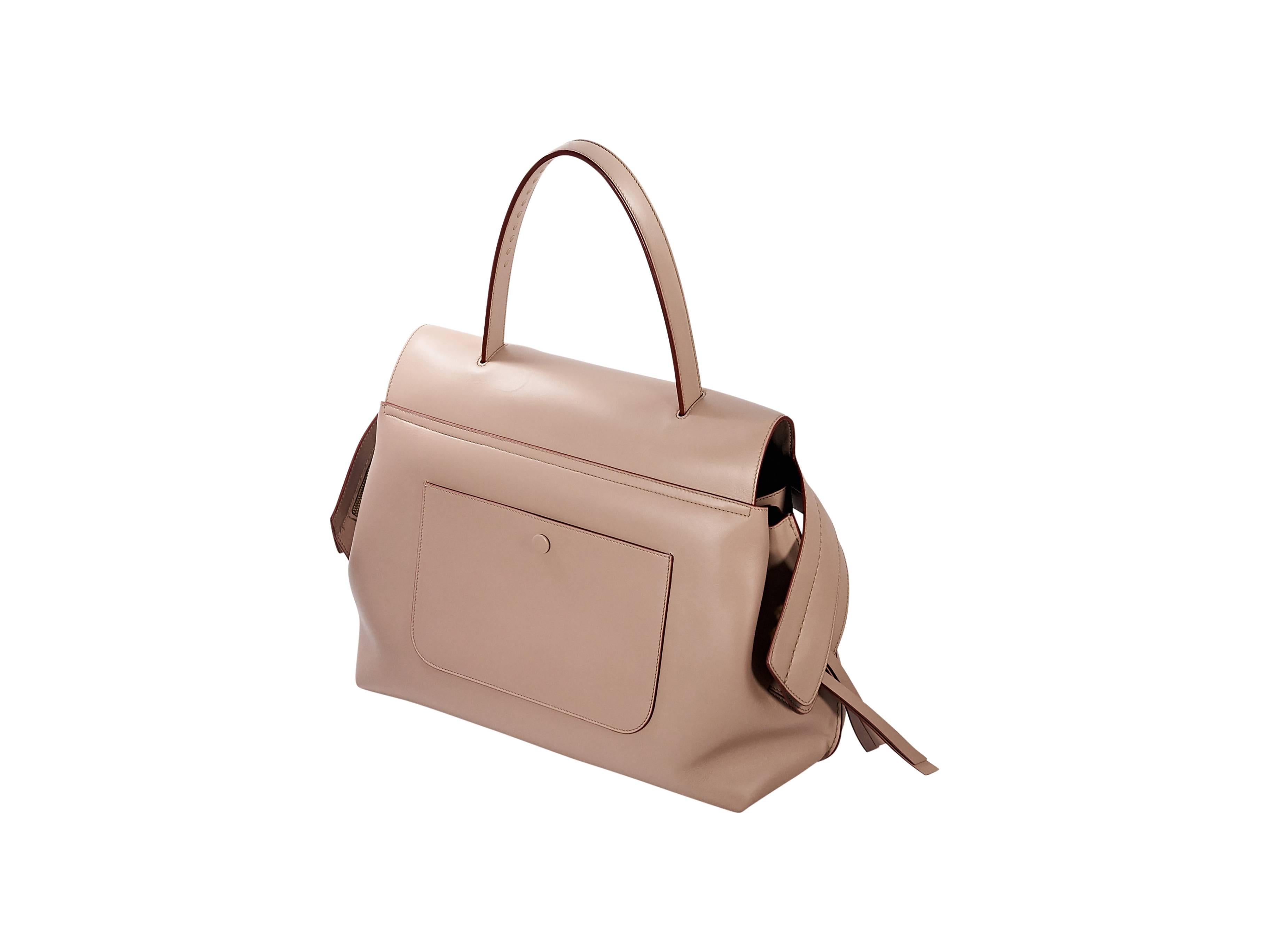 Product details: Pale pink leather Wave top-handle bag by Tod's. Concealed zip closure. Lined interior with inner zip pocket. Back exterior snap patch pocket. 14.5