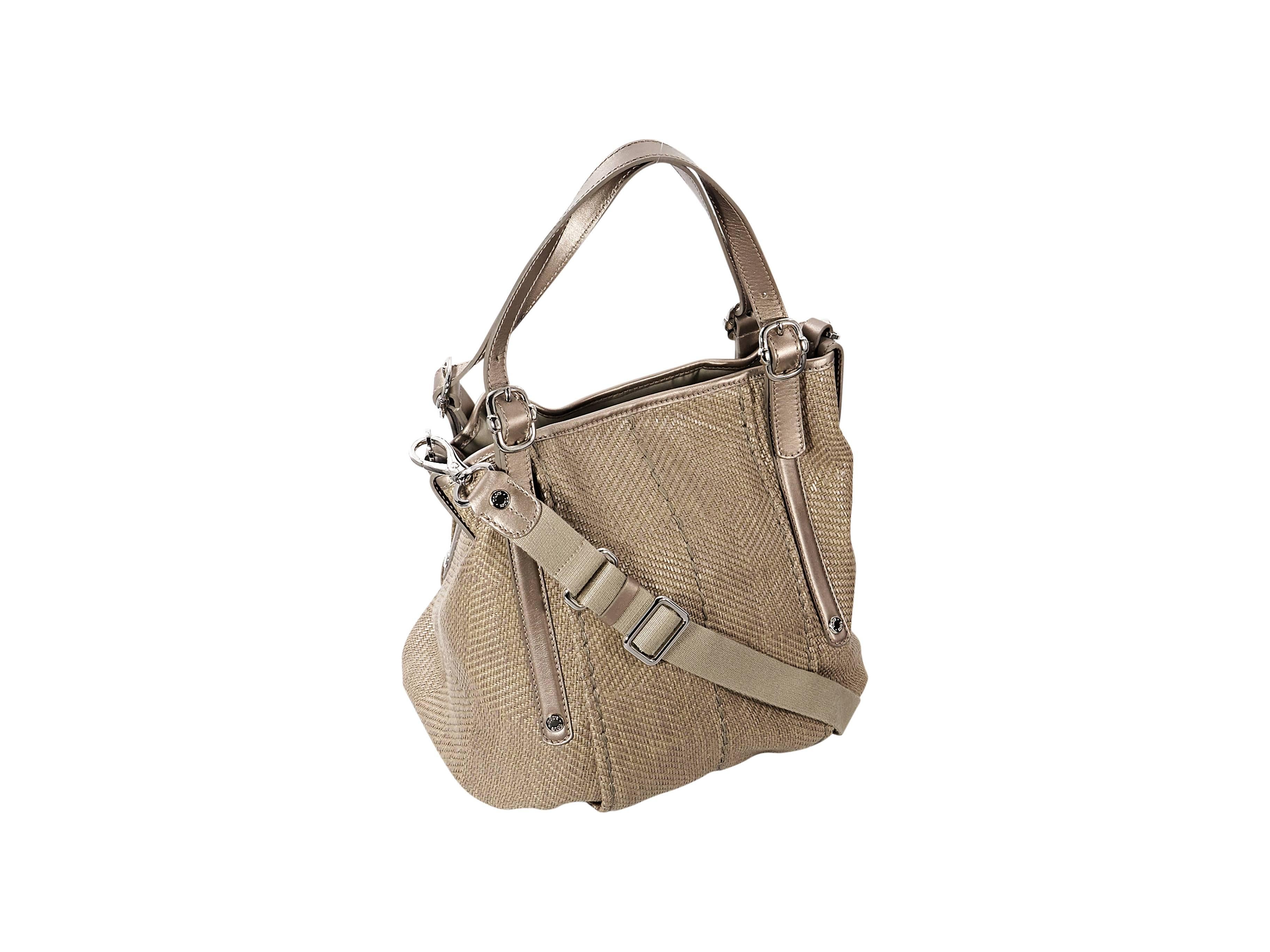 Product details: Tan woven satchel bag by Tod's. Trimmed with leather. Dual shoulder straps. Detachable, adjustable crossbody strap. Concealed snap closure. Lined interior with inner zip and slide pockets. Protective metal feet. Silverotne hardware.