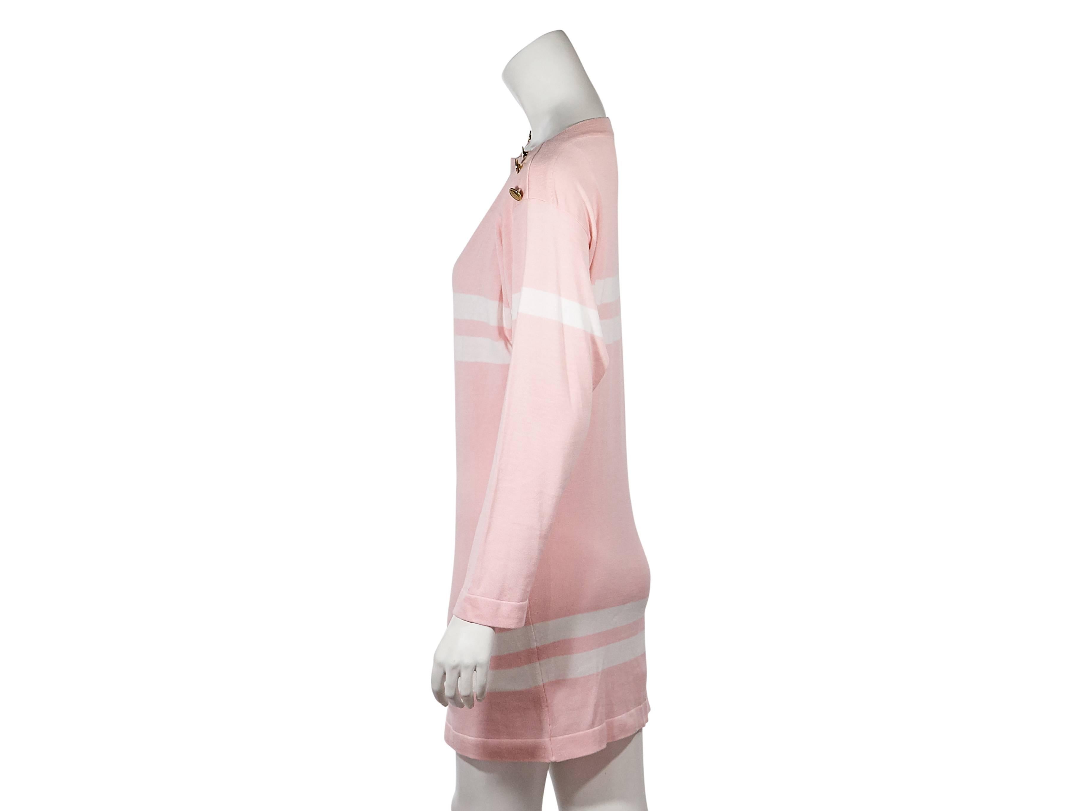 Product details:  Pink and white striped sweater dress by Chanel.  Boatneck.  Long sleeves.  Ribbed cuffs.  Button details accent shoulders.  Pullover style.  
Condition: Very good. 
Est. Retail $ 980.00