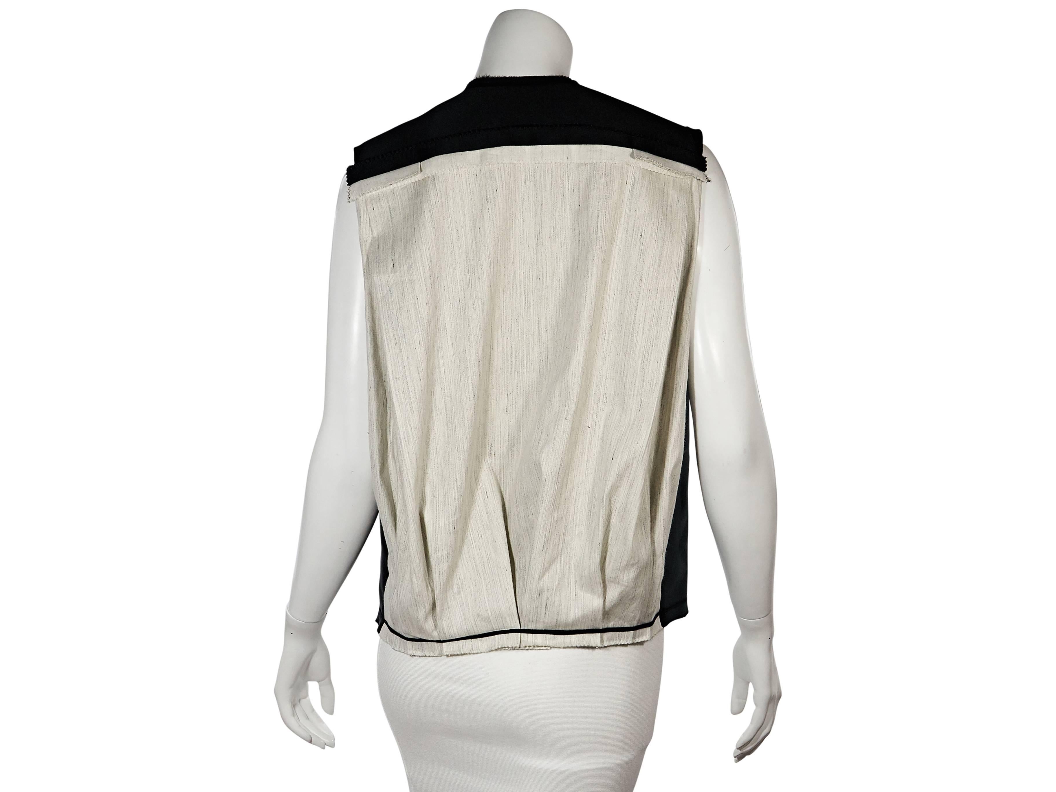 Product details: Black and beige silk-blend vest by Lanvin. Accented with bows. Sleeveless. Concealed front closure. 
Condition: Very good. 
Est. Retail $ 1,028.00