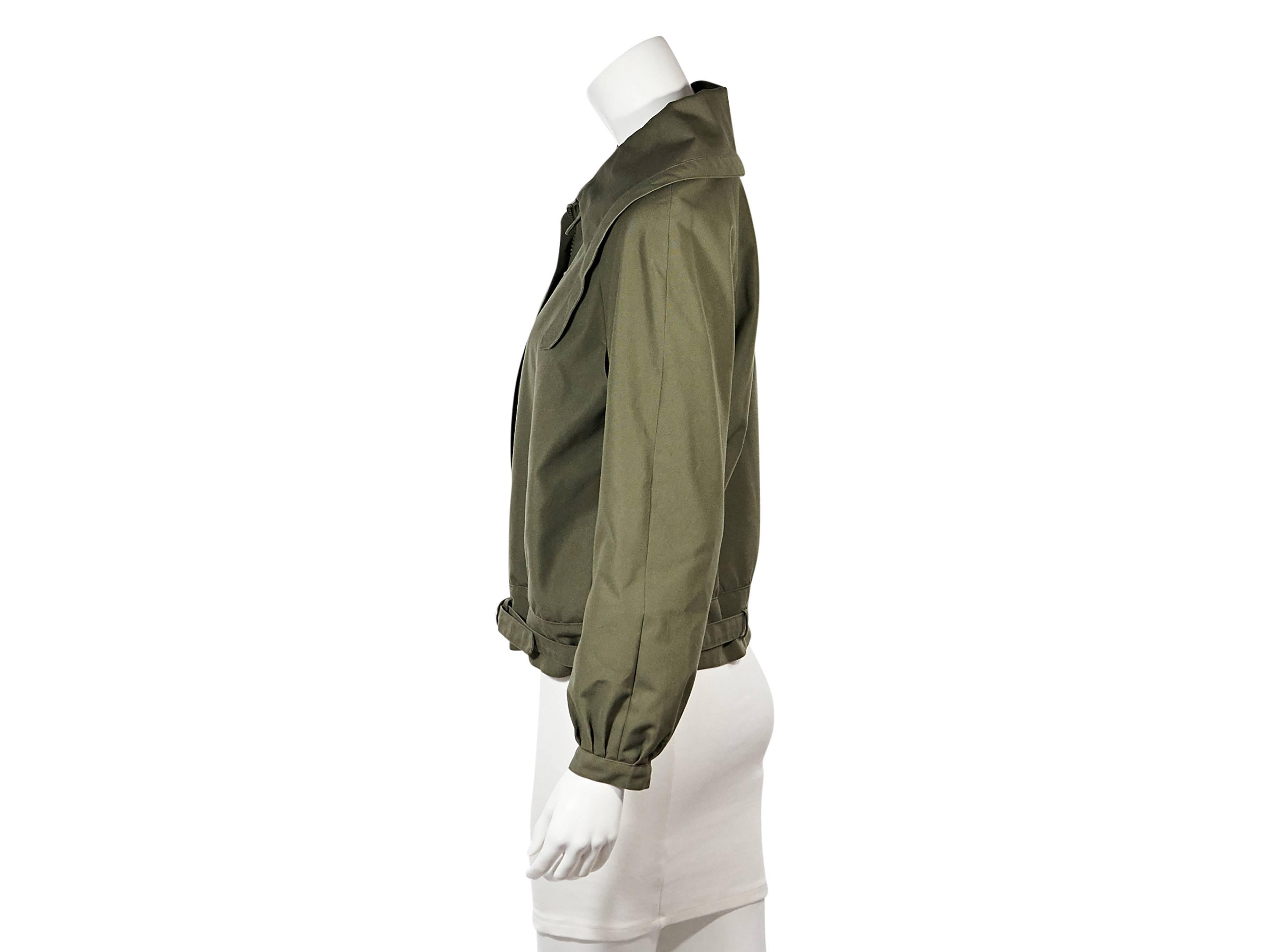 Product details: Olive zip-front jacket by Christian Dior. Oversize collar. Bracelet-length sleeves. Concealed zip-front closure. Adjustable hem strap. 
Condition: Very good. 
Est. Retail $ 730.00