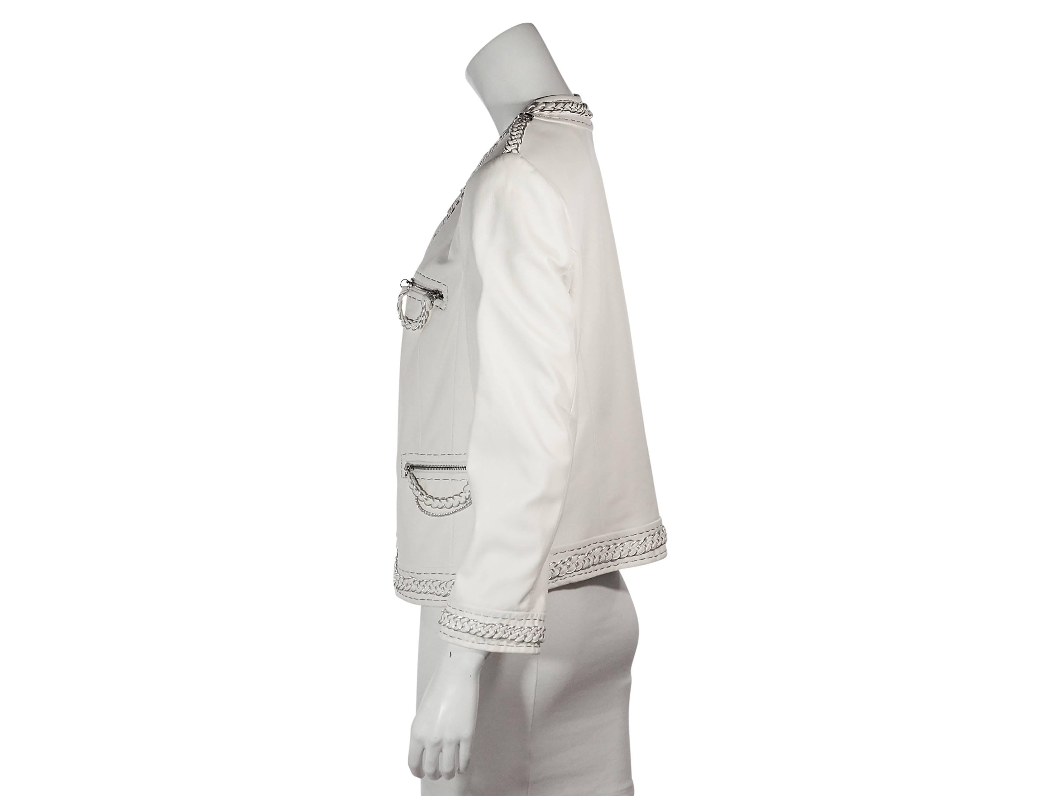 Product details: White leather jacket by Escada. Accented with braided metallic trim. Crewneck. Long sleeves. Shoulder epaulettes. Concealed zip-front closure. Four front zip pockets. Label size IT 42. 
Condition: Very good. 
Est. Retail $ 5,000.00