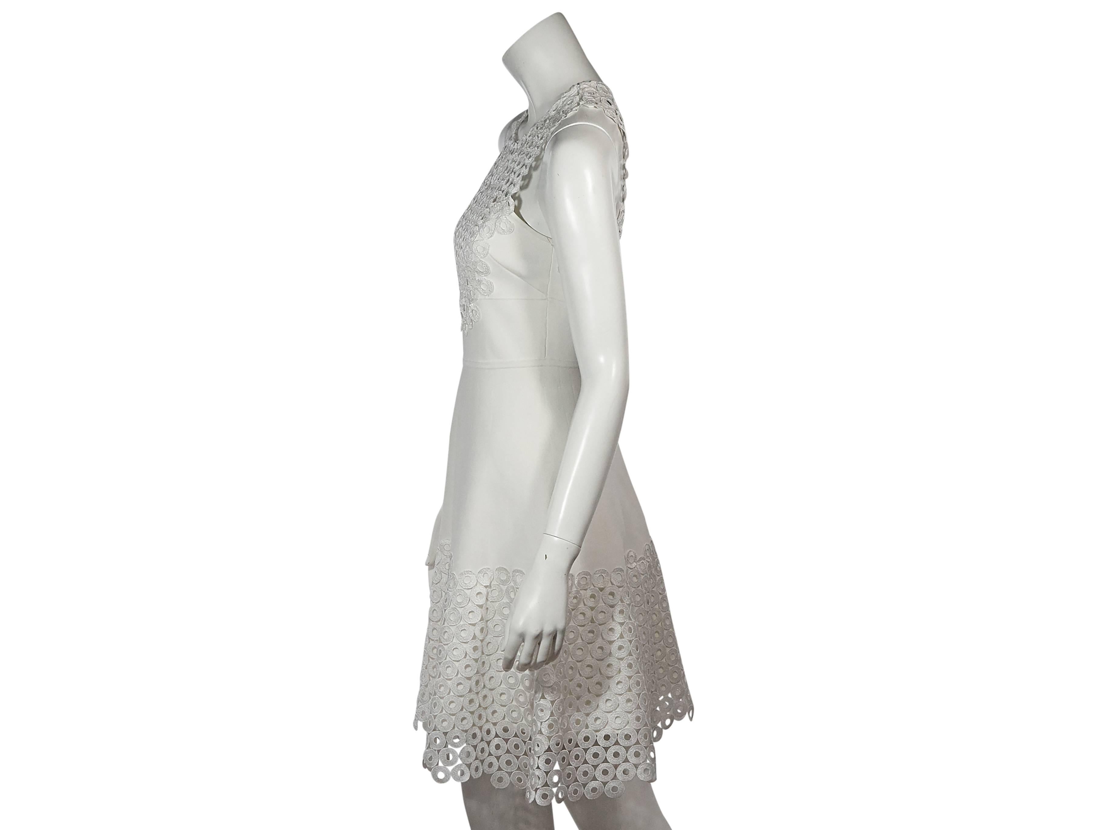Product details: White fit-and-flare eyelet dress by Lela Rose. Jewelneck. Sleeveless. Concealed back zip closure. 
Condition: Very good. 
Est. Retail $ 528.00