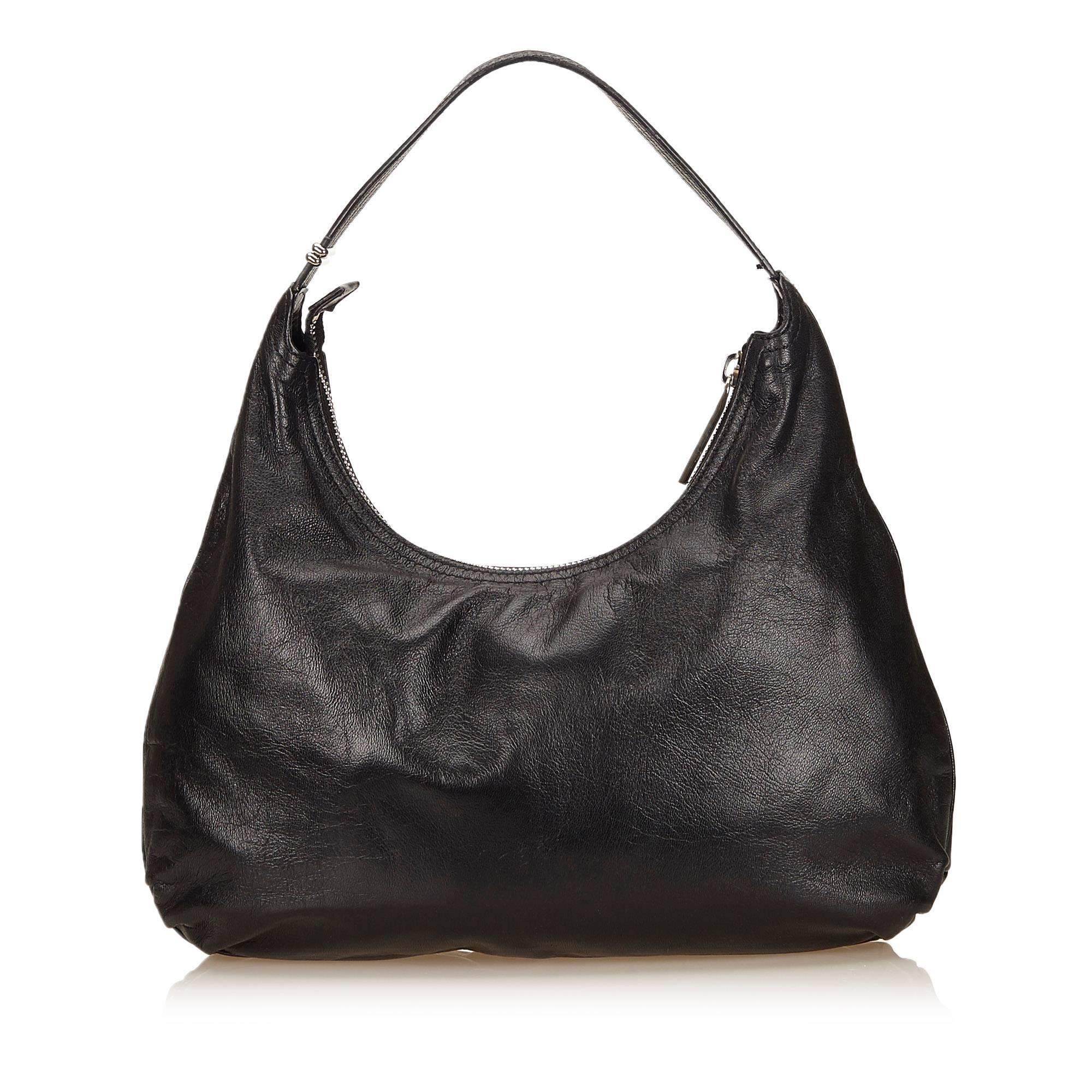 Product details: Black leather shoulder bag by Fendi. Single shoulder strap. Top zip closure. Lined interior with inner slide pockets. Front exterior pocket. Silvertone hardware. 14