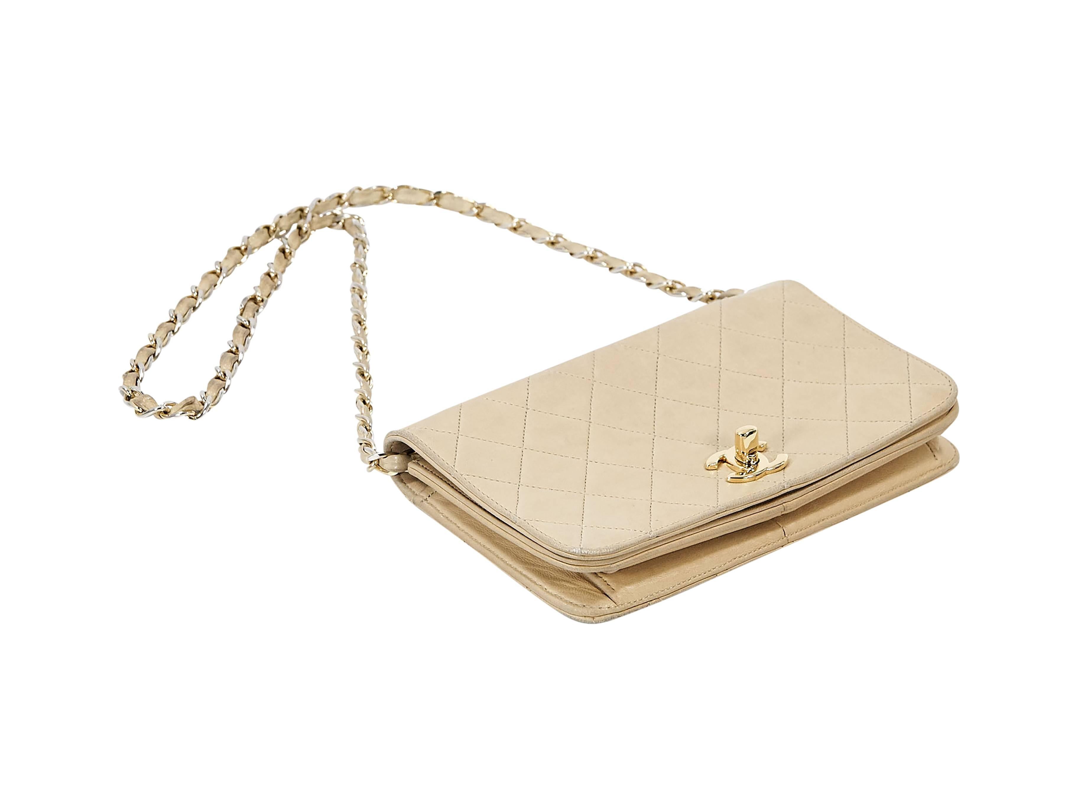 Product details: Tan quilted leather vintage crossbody bag by Chanel. Chain and leather crossbody strap. Front flap with twist-lock logo closure. Lined interior with inner slide pocket. Goldtone hardware. 8.5