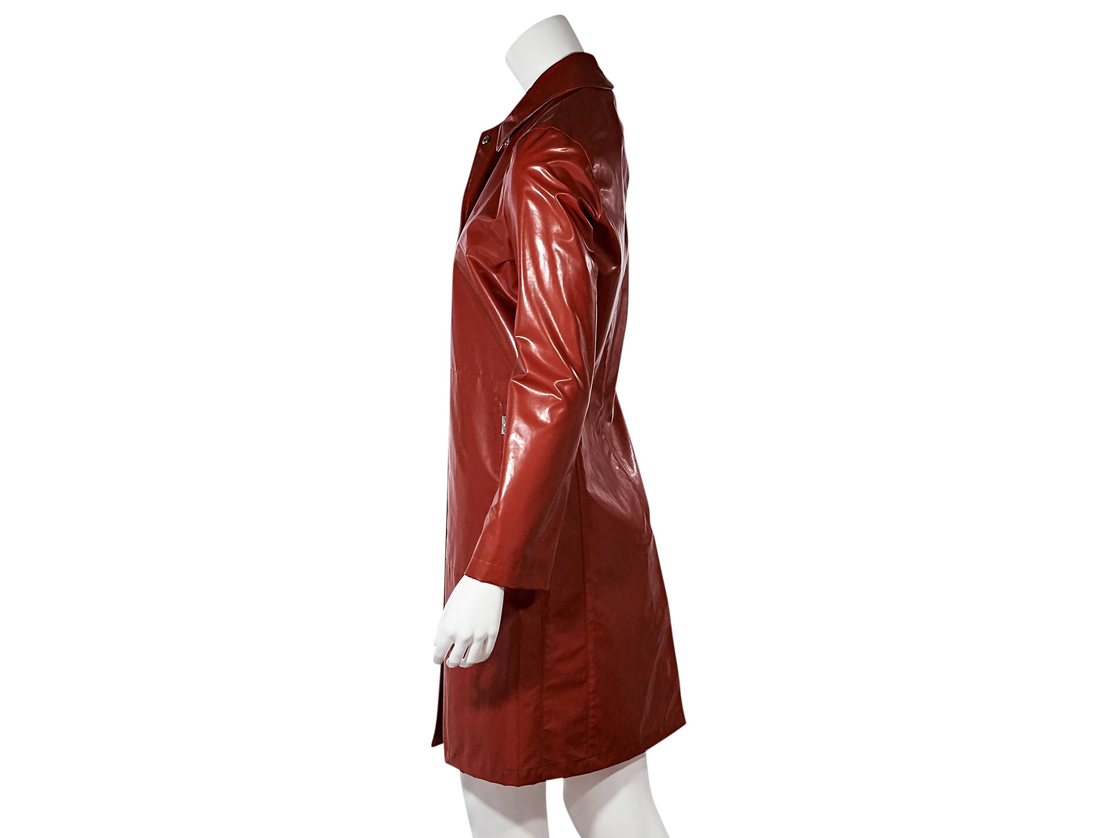 Product details:  Red coated raincoat by Burberry.  Spread collar.  Long sleeves.  Snap-front closure.  Side slide pockets.  Back center hem vent.  
Condition: New with tags. 
Est. Retail $ 730.00