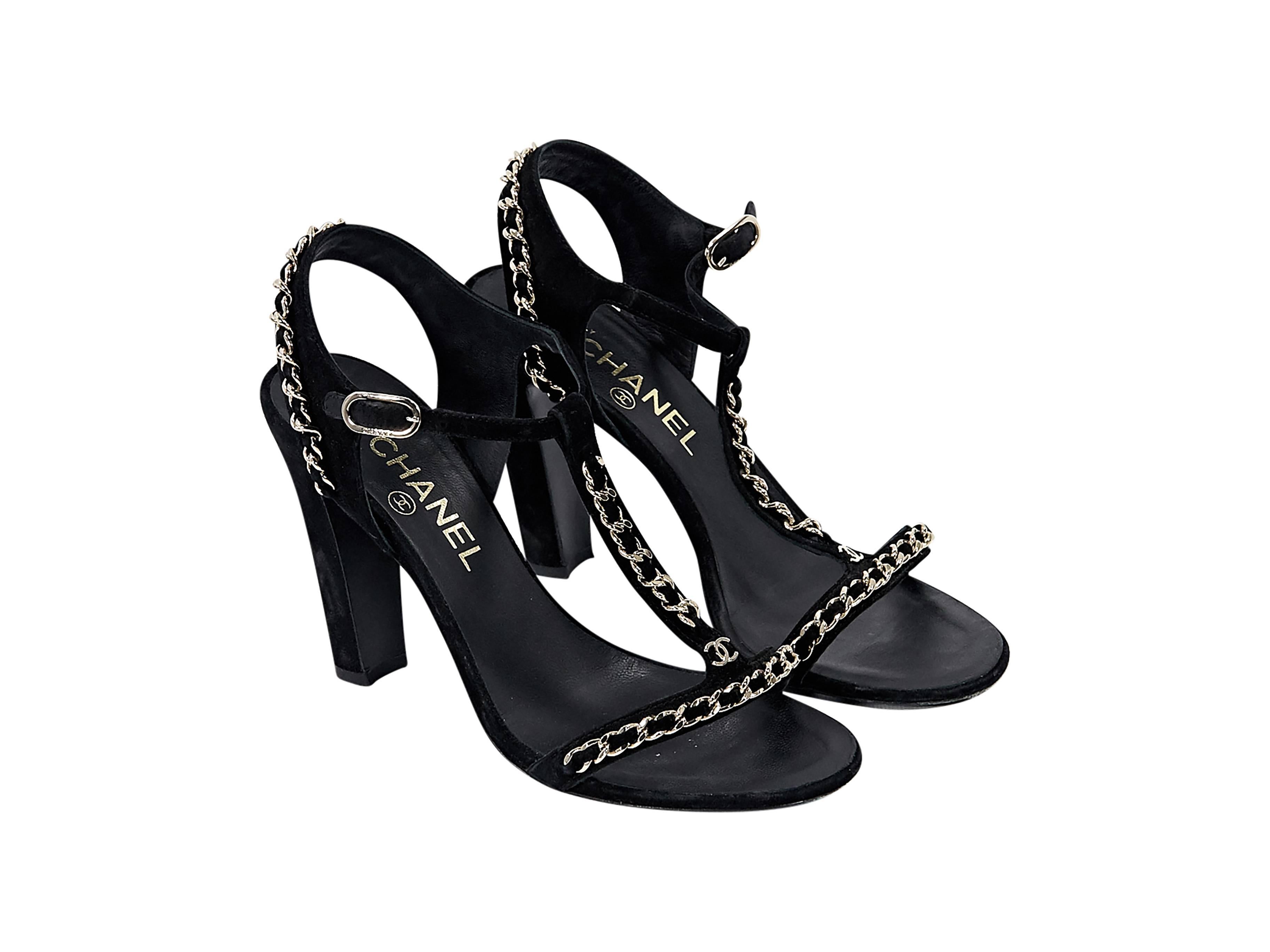 Product details: Black suede T-strap sandals by Chanel. Accented with chain details. Adjustable ankle strap. Open toe. Goldtone hardware.
Condition: Very good. 
Est. Retail $ 1,050.00