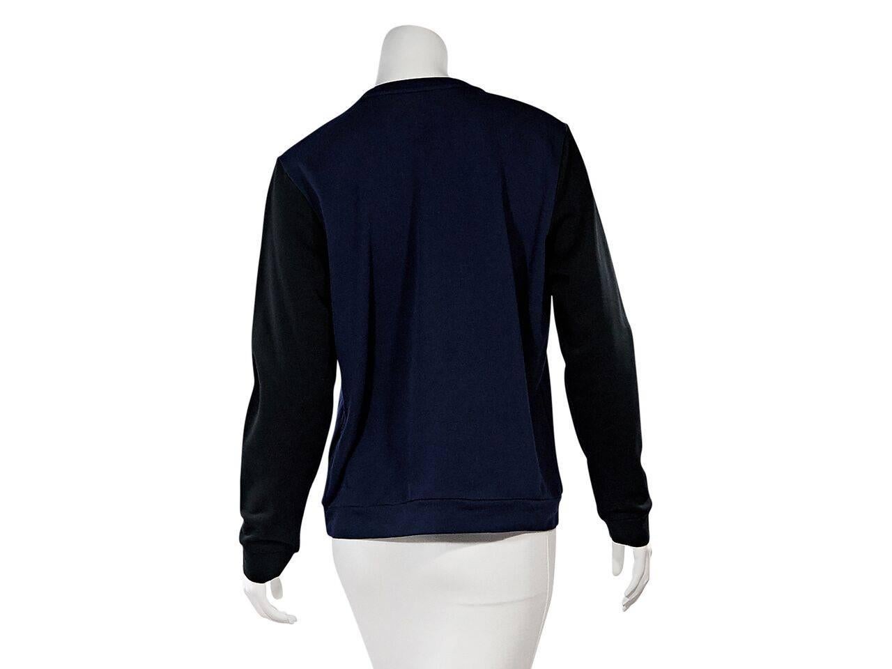 Product details:  Navy blue and black embellished sweatshirt by Lanvin.  Embellished with a tassel rope accents.  Crewneck.  Long sleeves.  Ribbed cuffs.  Pullover style.   
Condition: Pre-owned. Very good.
Est. Retail $ 748.00