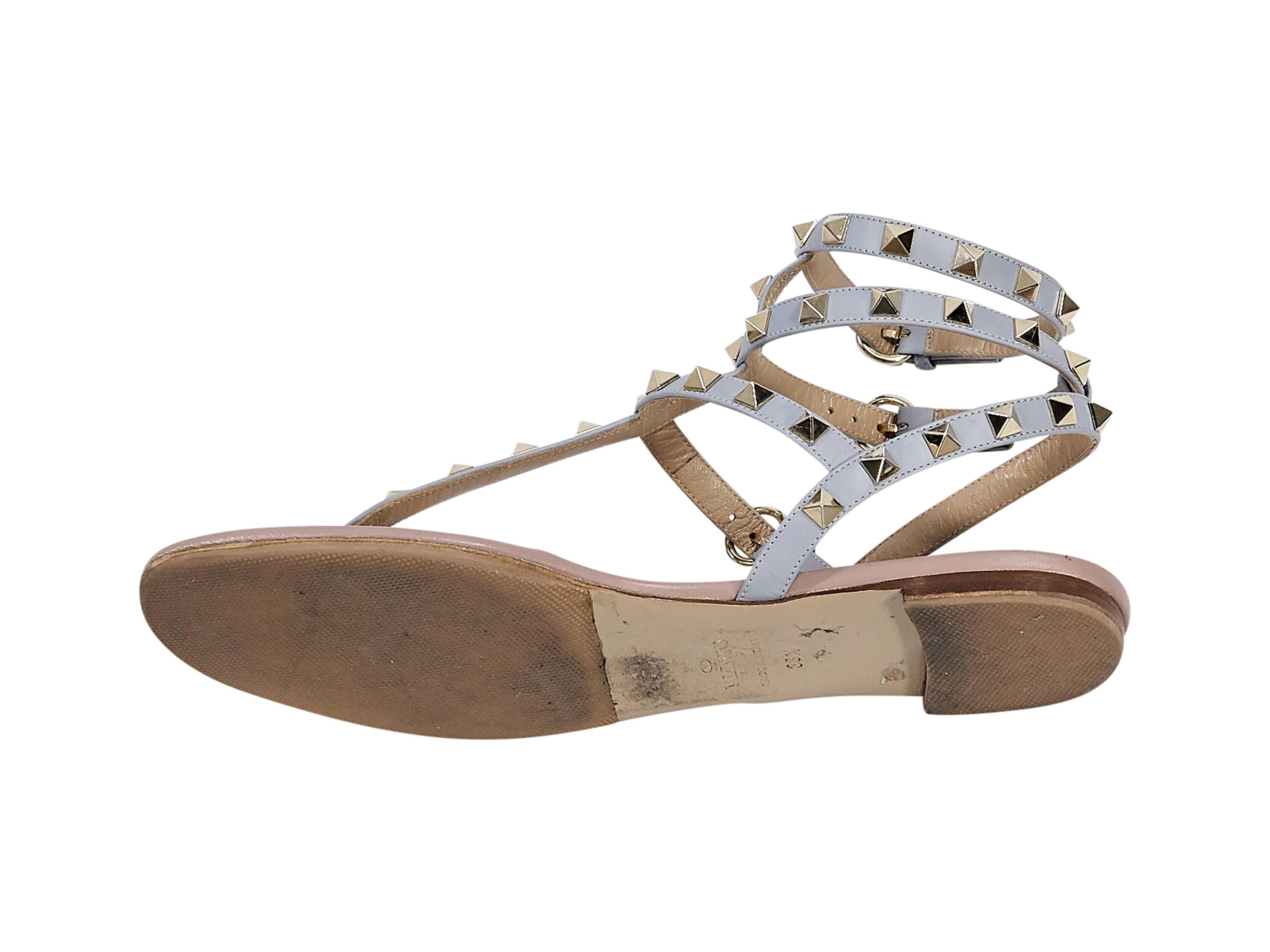 Product details:  Pale blue leather Rockstud sandals by Valentino.  Accented with signature pyramid studs.  Adjustable ankle straps.  T-strap design.  Goldtone hardware. 
Condition: Pre-owned. Very good.

Est. Retail $ 945.00
