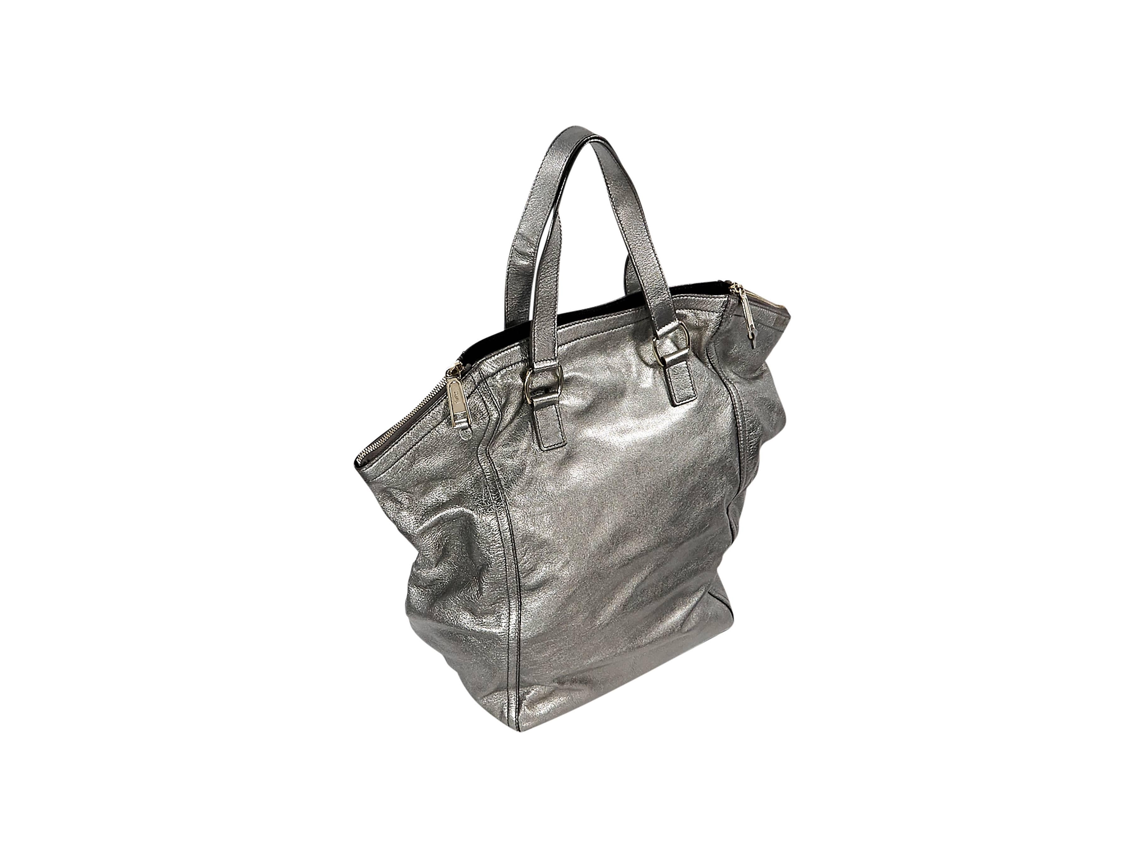 Product details:  Metallic silver leather Downtown bag by Yves Saint Laurent.  Dual carry handles.  Side top zip closures with open center.  Lined interior with inner zip pocket.  Goldtone hardware.  
Condition: Pre-owned. Very good.

Est. Retail $