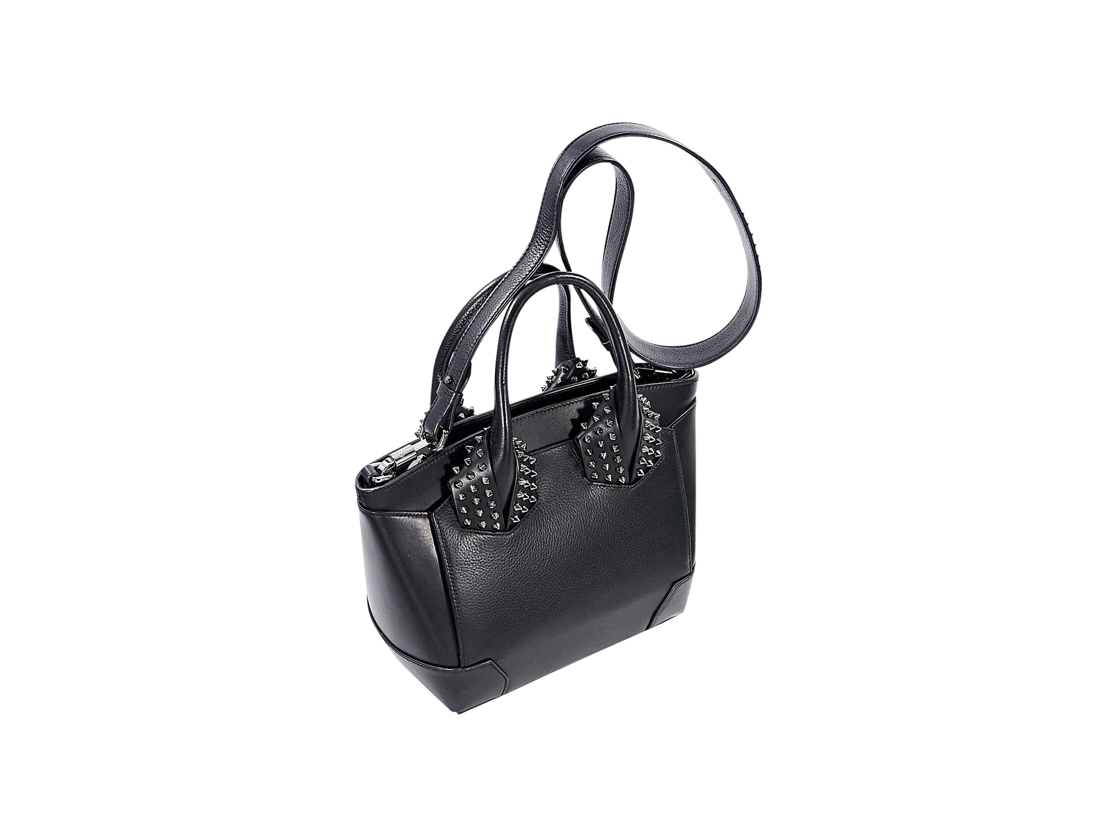 Product details:  Black leather studded Elouise satchel by Christian Louboutin.  Dual carry handles.  Detachable crossbody strap.  Center top zip compartment and two side open compartments.  Lined interior with inner zip pocket.  Protective metal