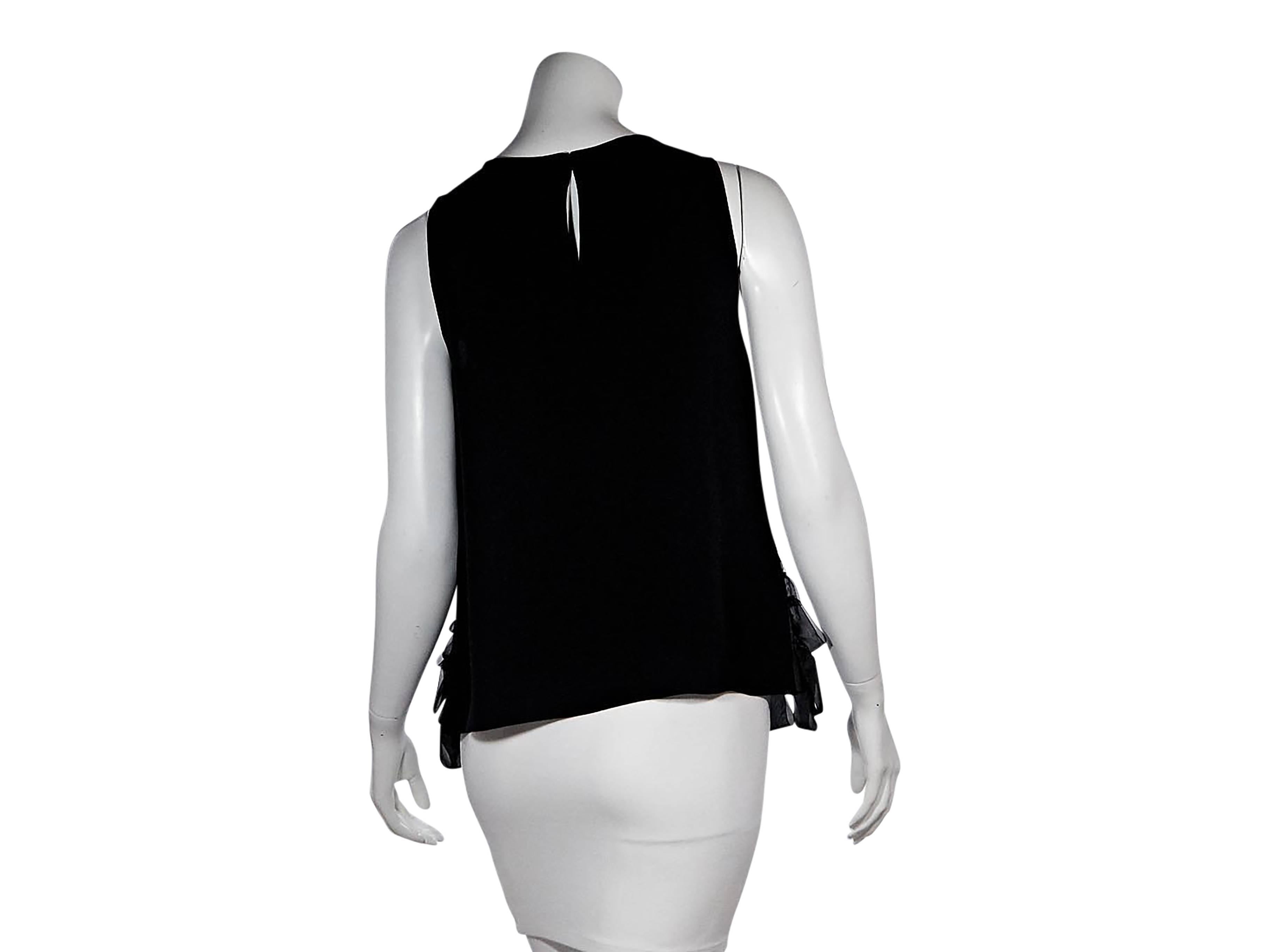Product details:  Black embellished tank by Carolina Herrera.  Scoopneck.  Sleeveless.  Back button closure with keyhole cutout. 
Condition: Pre-owned. Very good.

Est. Retail $ 798.00
