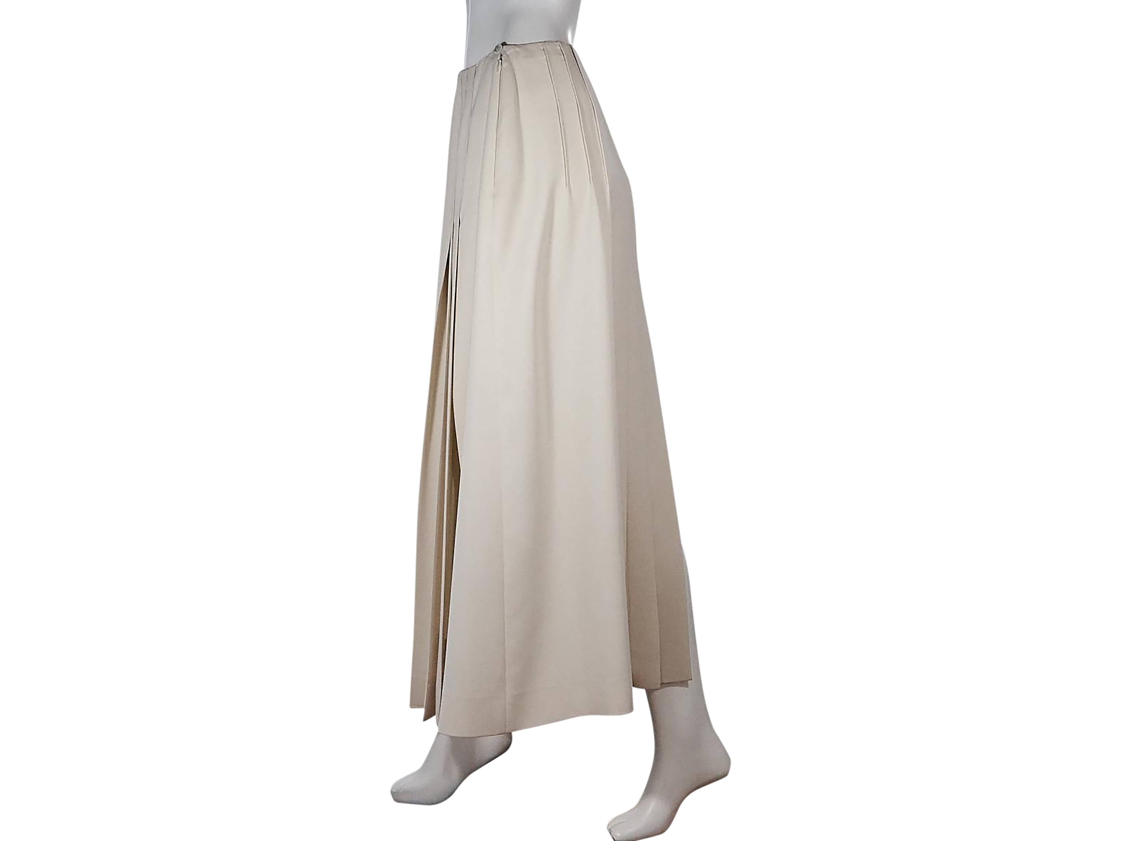 Product details:  Ivory pleated long skirt by Chanel.  Side button and concealed zip closure.  Back hem slit.   
Condition: Pre-owned. Very good.

$ 805.00