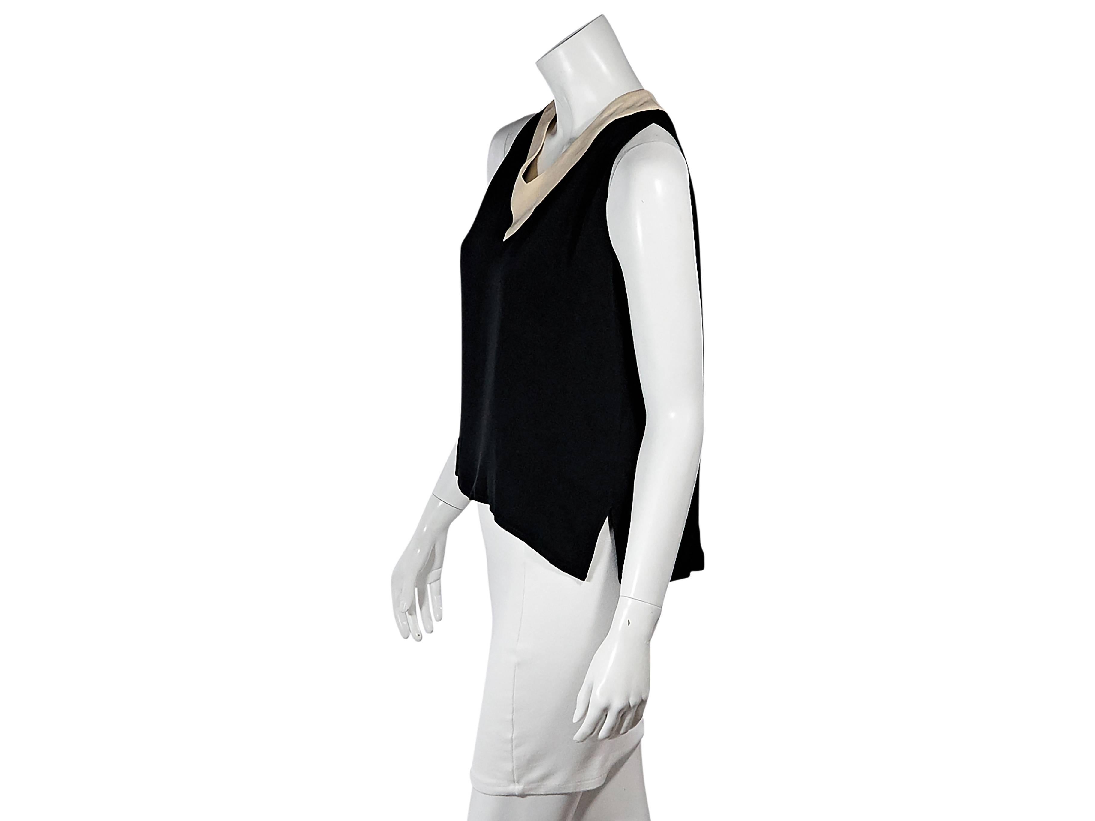 Product details:  Black vintage tank top by Chanel.  Banded tan trim.  V-neck.  Sleeveless.  Button back closure.  Hi-lo hem with side slits.    
Condition: Pre-owned. Very good.

Est. Retail $ 998.00
