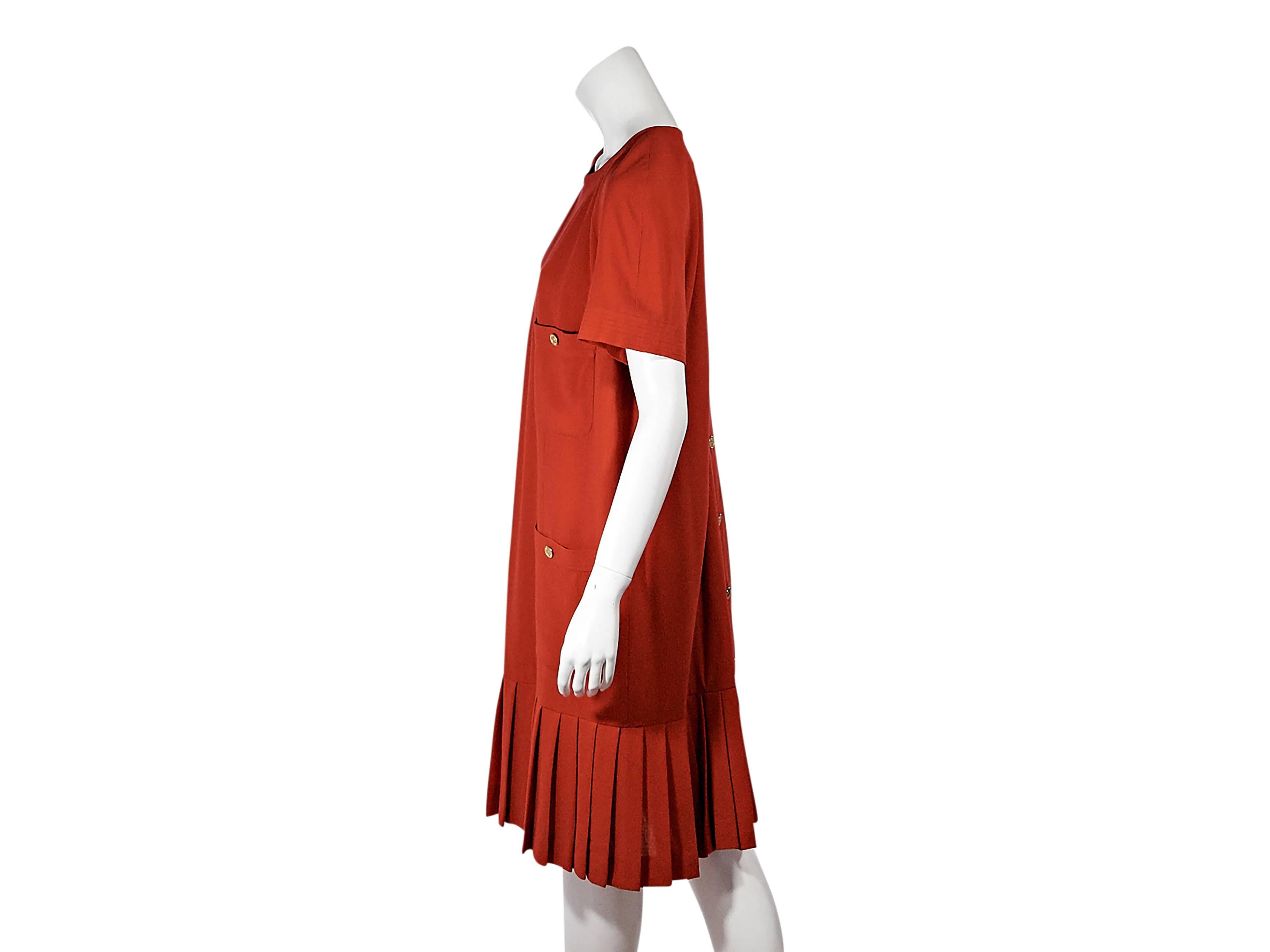 Product details:  Vintage red pleated dress by Chanel.  Jewleneck.  Short sleeves.  Front button patch pockets.  Button back closure.  Box pleated hem.  
Condition: Pre-owned. Very good.

Est. Retail $ 2,000.00