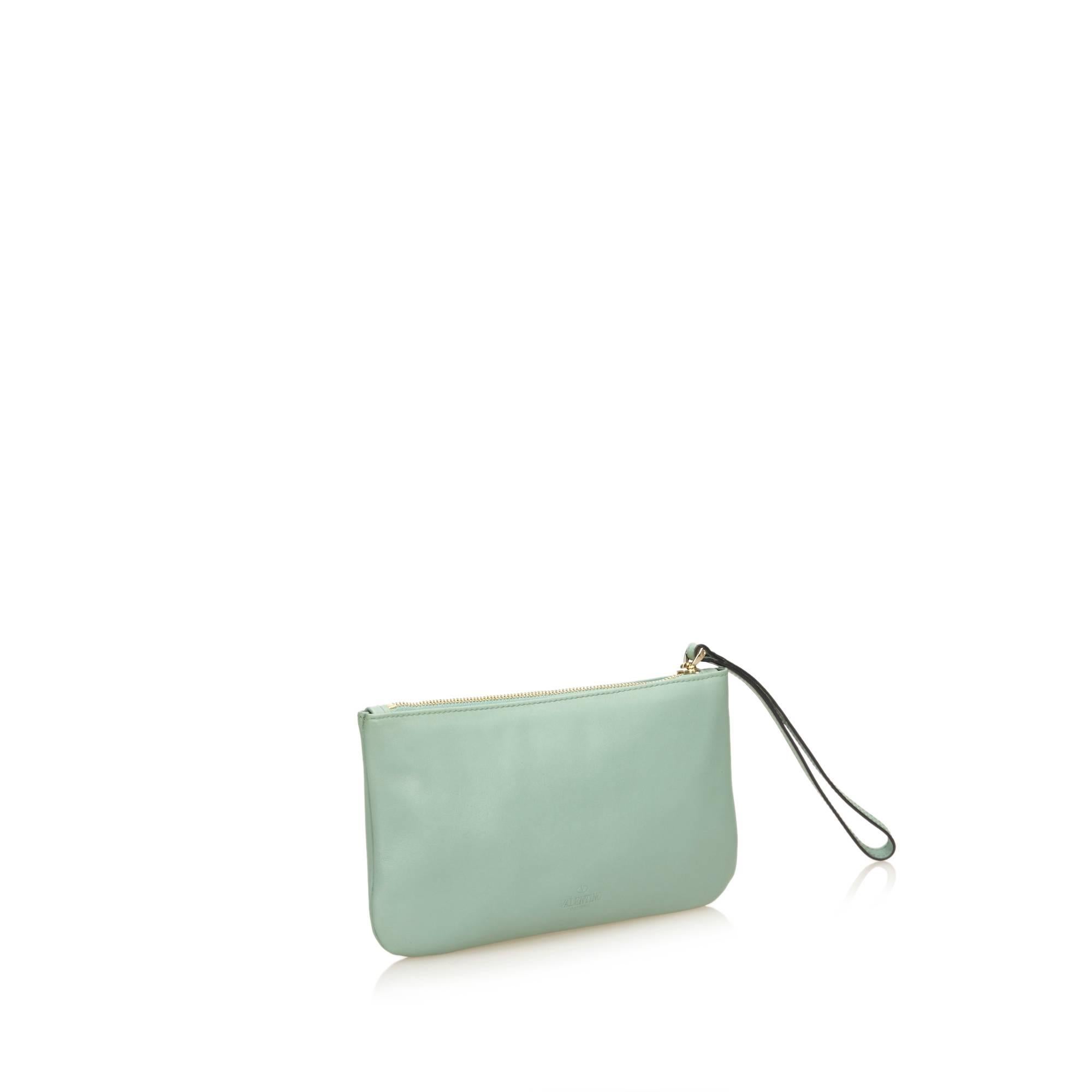 Product details:  Mint green leather wristlet by Valentino.  Top zip closure.  Wristlet strap.  Lined interior.  Goldtone hardware.  8